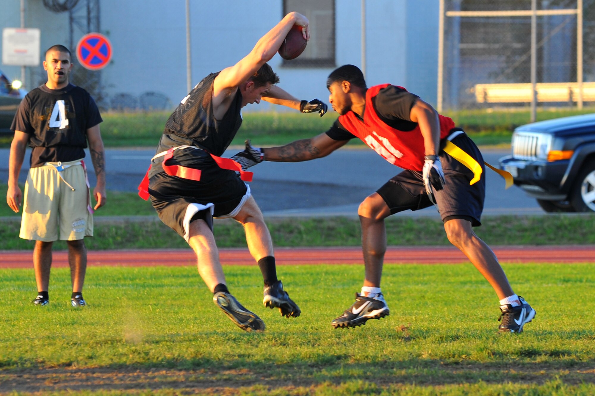 SPANGDAHLEM AIR BASE, Germany – Lucas Gross, 52nd Equipment Maintenance Squadron, dodges an attempt to end the play by Ricky Bruce, husband of Airman 1st Class Jennifer Bruce, 52nd Operations Support Squadron, during an intramural flag football game here Sept. 28. The 52nd EMS beat the 52nd Operations Group 6-0. (U.S. Air Force photo/Airman 1st Class Dillon Davis)