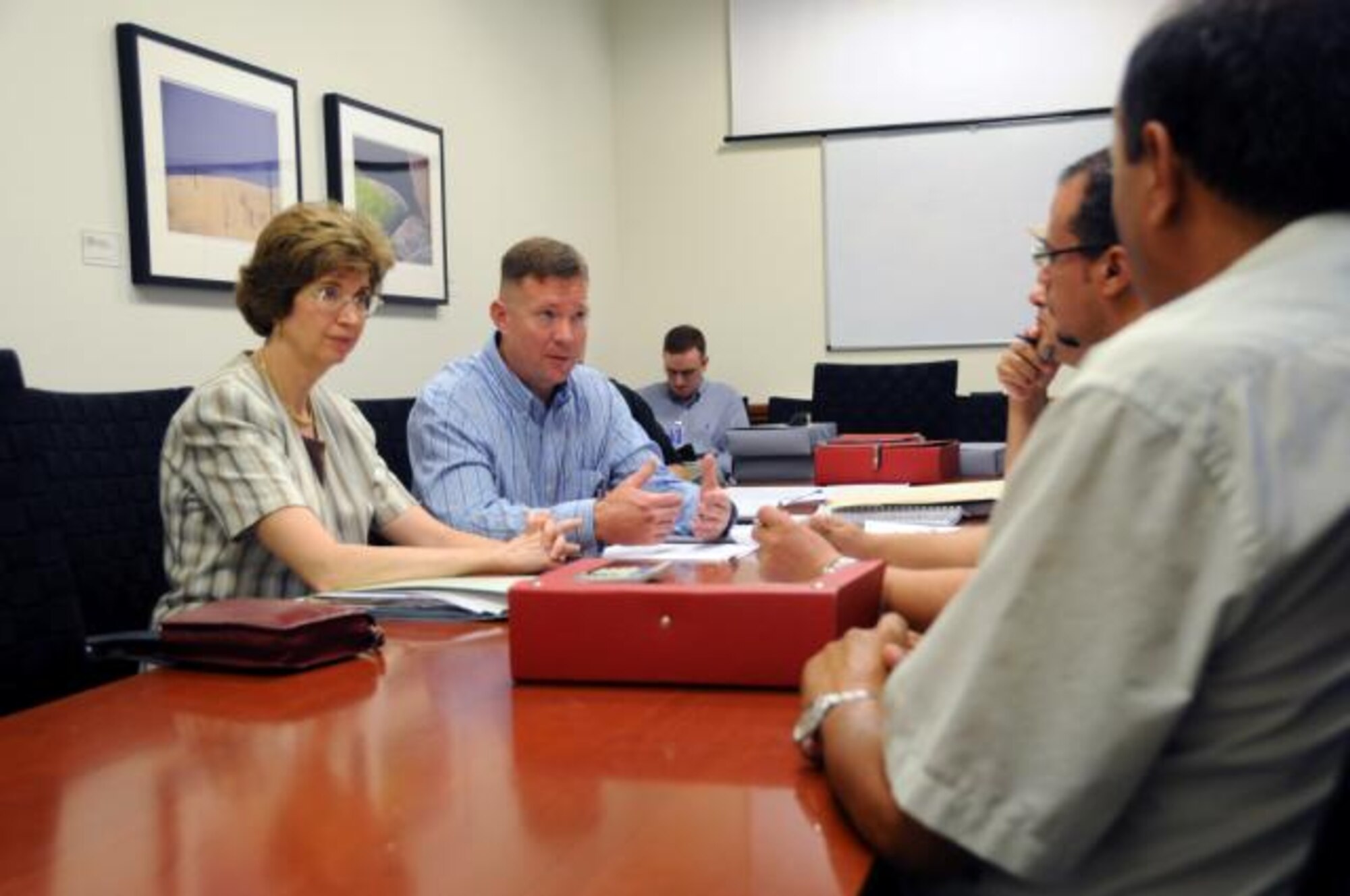 TUNIS, Tunisia -- Toni Metcalfe-El Abed (left), the U.S. Embassy’s Humanitarian Assistance Program Officer, and Master Sgt. David Roux, 17th Air Force contracting officer, discuss negotiations with potential contractors to build a woman’s vocational center in Mahthar, Tunisia. The U.S. government has provided $500,000 for the construction to provide vocational training to the local rural population in that region. (U.S. Air Force photo by Staff Sgt. Stefanie Torres)
