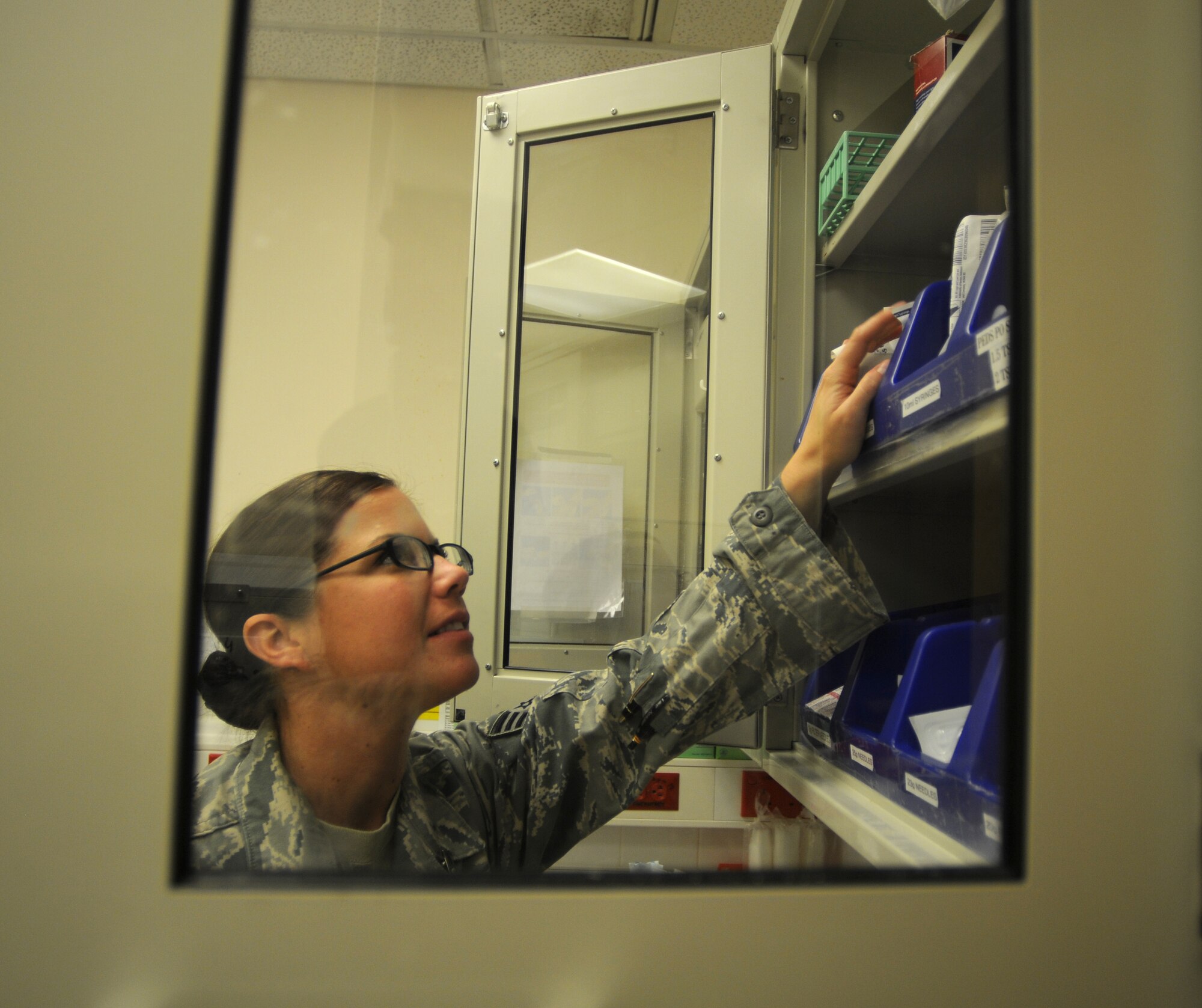 ROYAL AIR FORCE LAKENHEATH, England - Senior Airman Krystle Clark48th Inpatient Care Squadron Multi-Service Unit medical technician, reaches for equipment on Sept 26, 2011.  The MSU cares for approximately 280 inpatients and 20 specialty care patients per year. (U.S. Air Force photo by Airman Cory D. Payne)