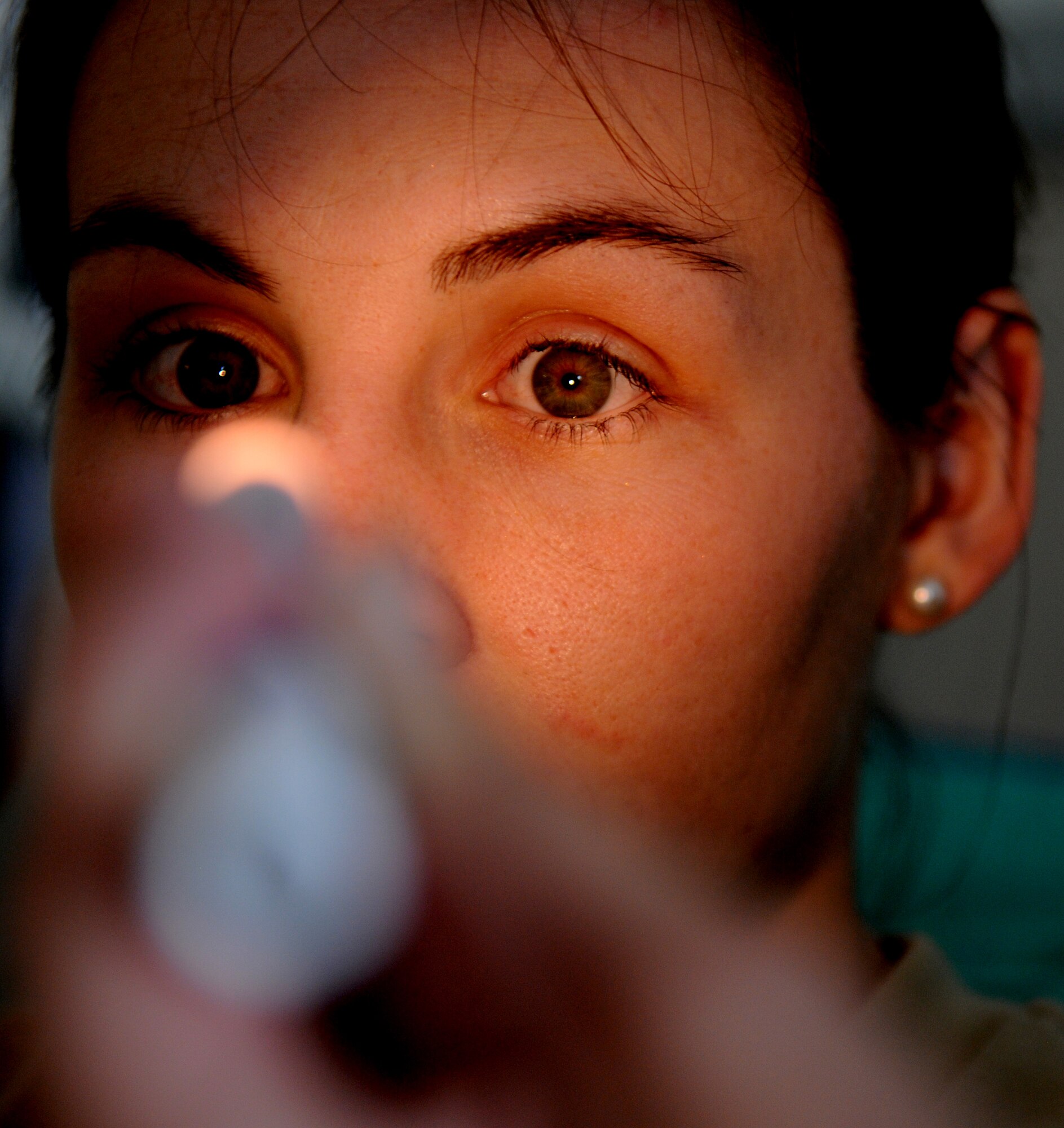 ROYAL AIR FORCE LAKENHEATH, England - Capt. Mary Pride, 48th Inpatient Care Squadron Multi-Service Unit clinical nurse, checks a patient?s eyes on Sept 26, 2011.  The MSU provides care to post operation patients and directs admissions from various clinics and the emergency room. (U.S. Air Force photo by Airman Cory D. Payne)