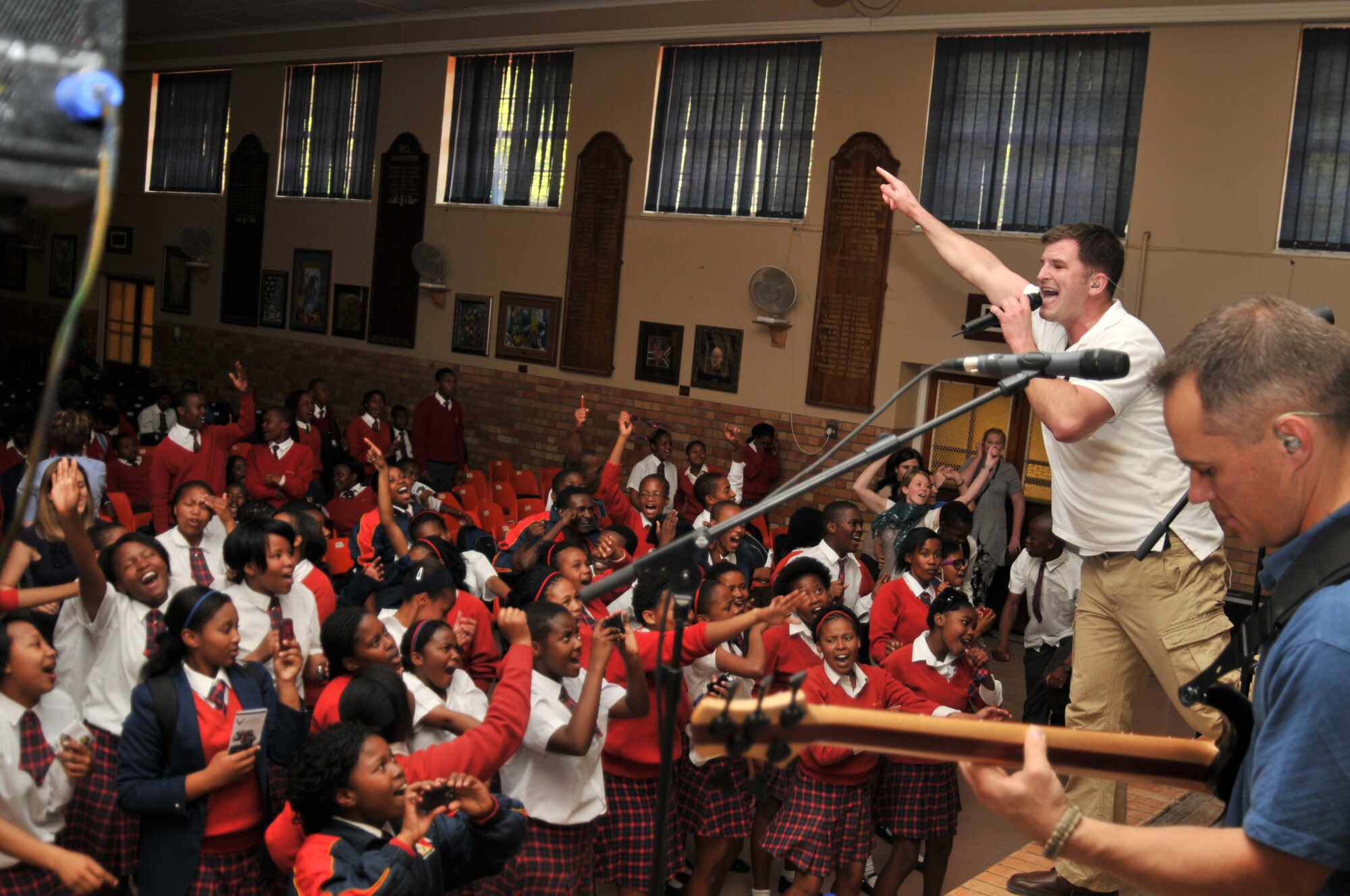BLOEMFONTAIN, South Africa - Students cheer for the U.S. Air Forces in Europe Band “Touch ‘n Go” as they perform Sept. 28 at Navalsig High School. More than 150 students and faculty stayed after school to hear the group perform several popular American rock songs. (U.S. Air Force photo by Staff Sgt. David Dobrydney)
