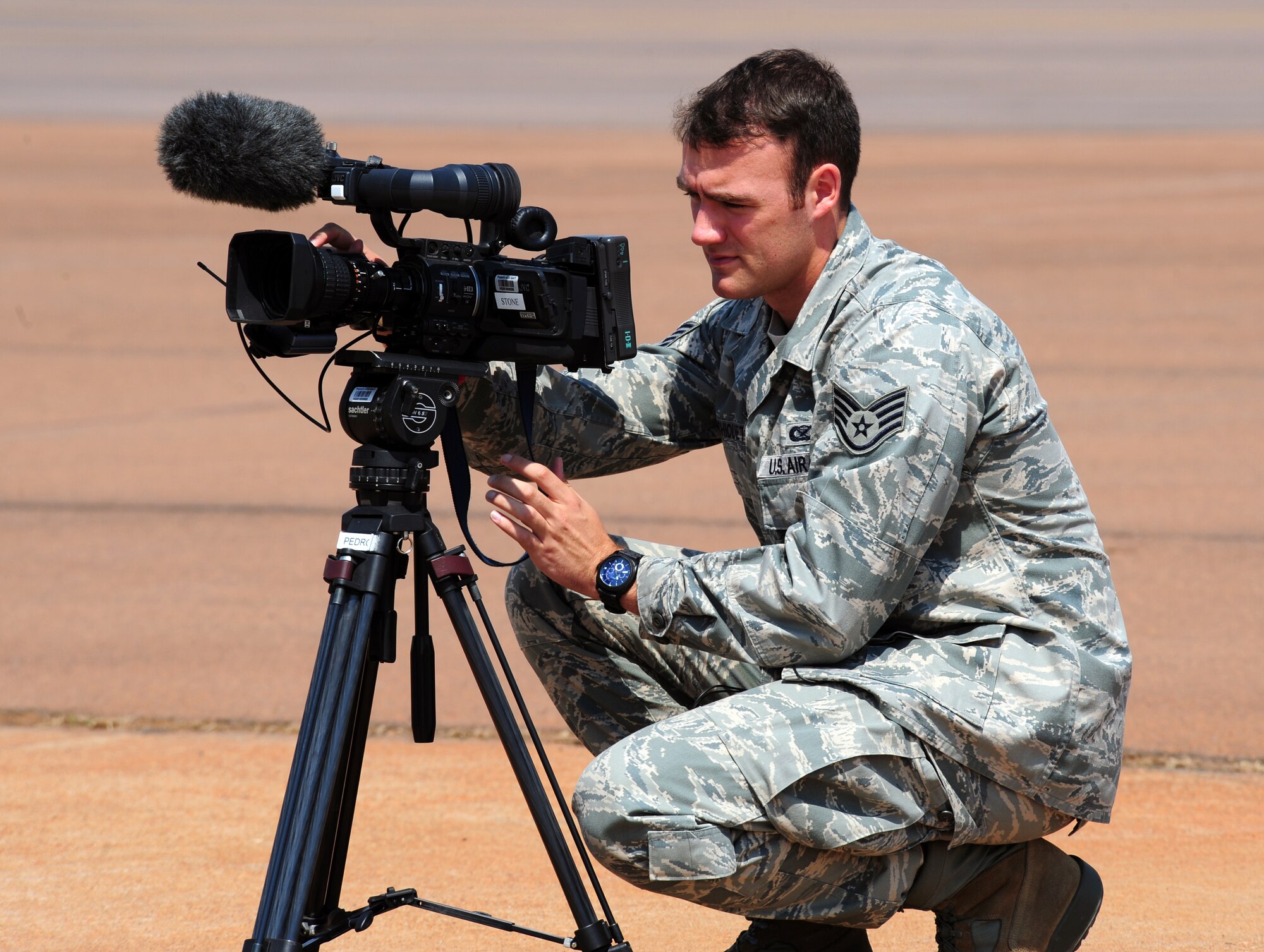 Pretoria, South Africa -- Staff Sgt. John Archiquette, Broadcast Producer for the American Forces Network from Ramstein Air Base, Germany shoots some footage of a static display prepositioned at Waterkloof Air Force Base during the 2011 Air show & Lifestyle Expo practice, Sept. 29, 2011. More than 50,000 South Africans are expected to attend this year’s event in which four aircraft from the U.S. Air Force fleet will be on display. (U.S. Air Force photo by Tech. Sgt. Todd Wivell)