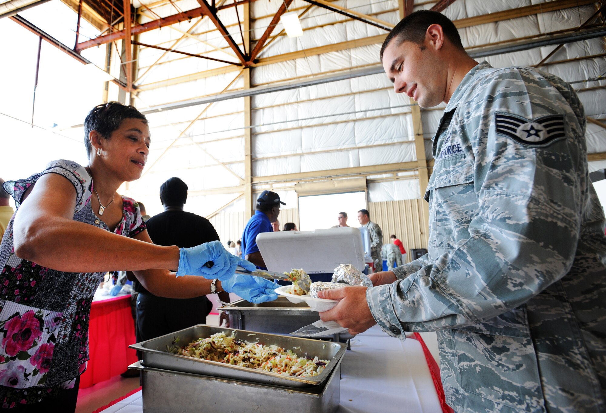 Mrs. Carol Brooks wife of U.S. Army Lt. Gen. Vince Brooks, 3rd Army Army Central commander serves food to Airmen and Soldiers during the Military Appreciation Picnic, Shaw Air Force Base, S.C., Sept. 29, 2011. It was the third annual picnic organized by the Sumter Chamber of Commerce's military affairs committee. Approximately 200  volunteers participated in the event. (U.S. Air Force photo by Airman 1st Class Tabatha Duarte/Released)