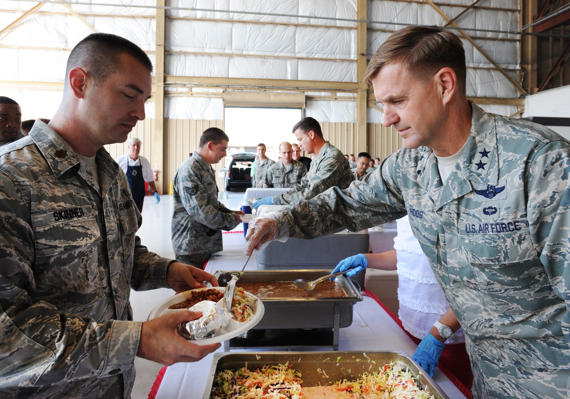 U.S. Maj. Gen. Stephan Hoog, 9th Air Force commander, and Col. Charlie Moore, 20th Fighter Wing commander, help serve Airmen and Soldiers food during Military Appreciation Picnic, Shaw Air Force Base, S.C., Sept. 29, 2011. It was the third annual picnic organized by the Sumter Chamber of Commerce's military affairs committee. Approximately 200 volunteers participated in the event. (U.S. Air Force photo by Airman 1st Class Tabatha Duarte/Released)