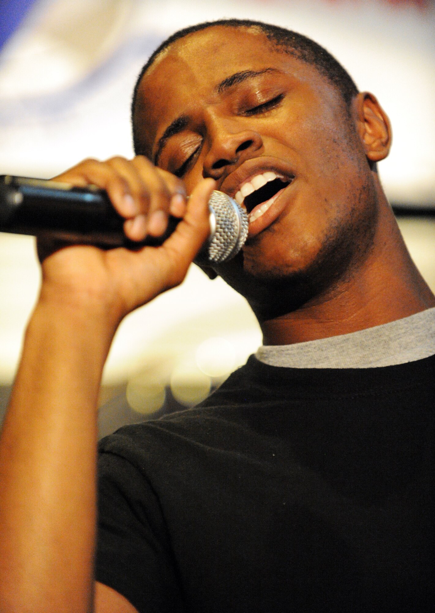 U.S. Army Spc. Tavon Deas, 3rd Army signal support system specialist, performs a song that he wrote during Shaw Idol at Carolina Skies Club, Shaw Air Force Base, S.C., Sept. 28, 2011. Shaw Idol was a four-week long singing competition in which John Kennedy, 20th Force Support Squadron school liaison officer, took the first place win and U.S. Air Force Senior Airman Courtney Slater, 20th Medical Support Squadron medical material journeyman, took second place. (U.S. Air Force photo by Airman 1st Class Tabatha Duarte/Released)