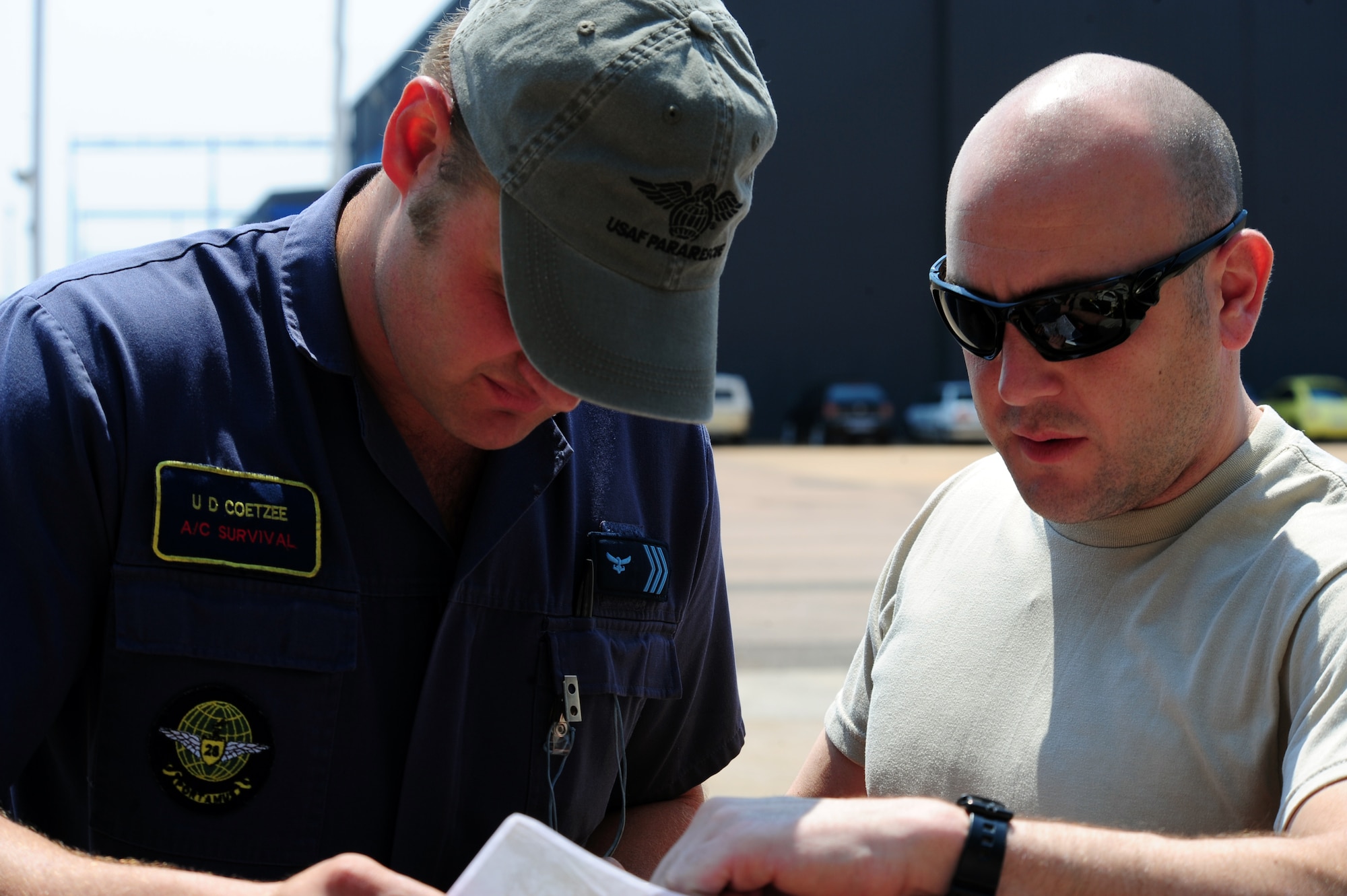 Pretoria, South Africa -- Master Sgt. Joe Spadavecchia (right), Guardian Angel assigned to the 103rd Rescue Squadron, Gabreski Airport, New York looks over a map of the proposed drop zone for the Guardian Angels during the 2011 Air show & Lifestyle Expo practice at Waterkloof Air Force Base, Sept. 29, 2011.  The Guardian Angels are an elite group of U.S. Air Force team members who are demonstrating their abilities during the air show scheduled for Oct. 1, 2011. (U.S. Air Force photo by Tech. Sgt. Todd Wivell)