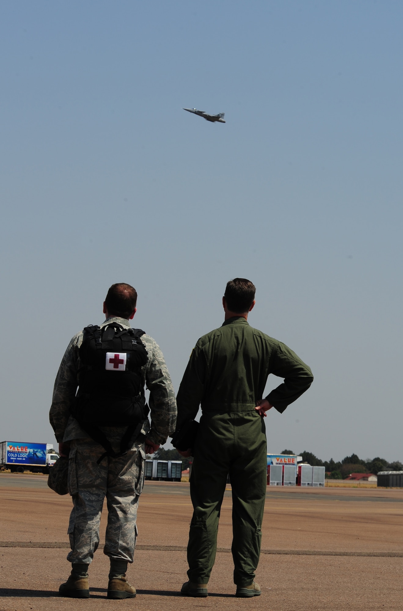 Pretoria, South Africa -- Col. Mark Loeben (right), 404th Air Expeditionary Group Commander, U.S. Air Forces Africa and Maj. Bob Baltzer, International Health Specialist and Flight Surgeon for the U.S. Air Forces assigned to the South African Air Show, look on as a South African Air Forces Gripen conducts a fly-by during the 2011 Air show & Lifestyle Expo practice at Waterkloof Air Force Base, Sept. 29, 2011.  More than 90 U.S. Air Force active duty, Reserve and National Guard members converged in Pretoria, SA for this year’s annual air show. (U.S. Air Force photo by Tech. Sgt. Todd Wivell)