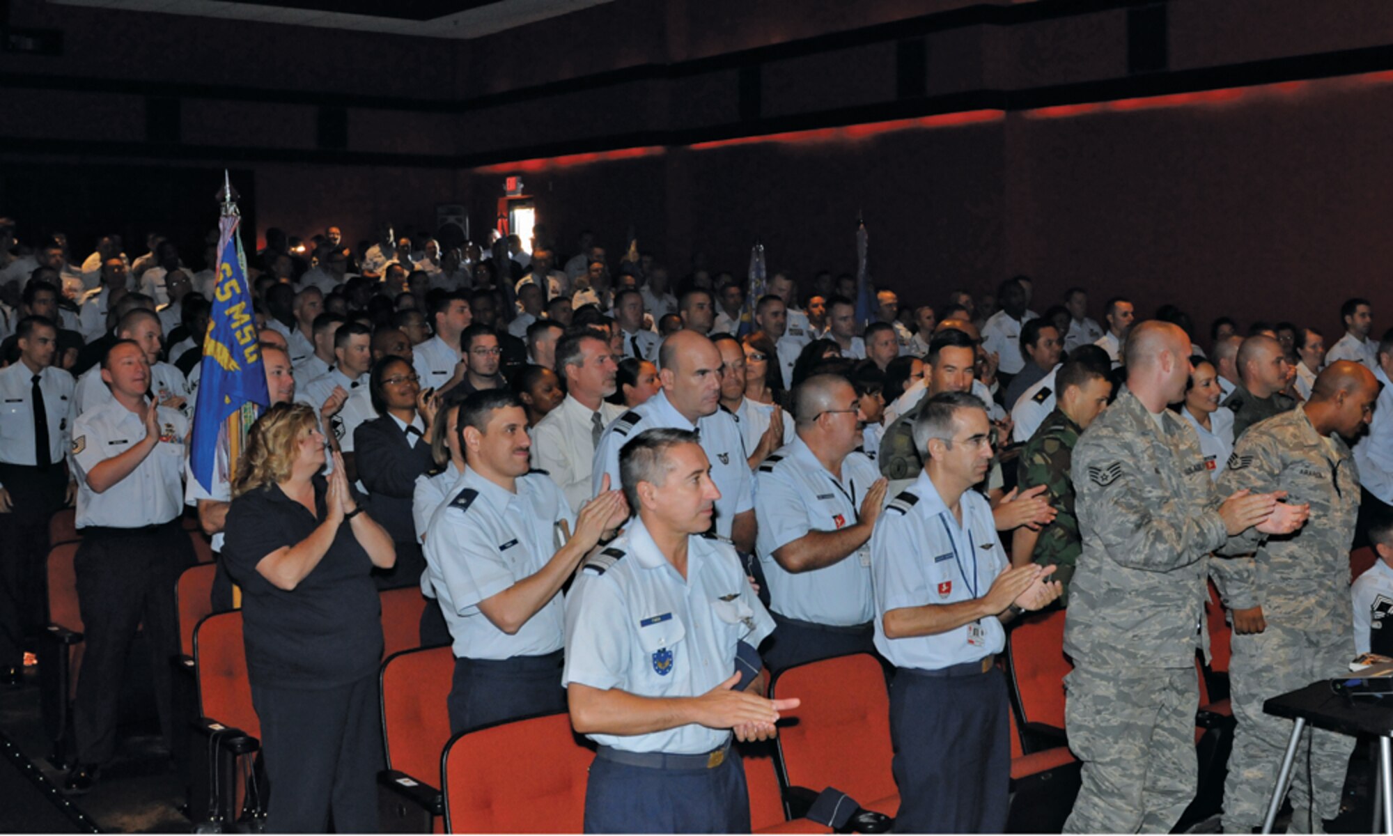 Lajes "A"irmen and their Portuguese counterparts applaud as the U.S. Air Forces in Europe’s Inspector General’s team announces the overall “Excellent” rating for the 65th Air Base Wing during the Operational Readiness Inspection out-brief Sept. 19, 2011.   (Photo by Guido Melo)