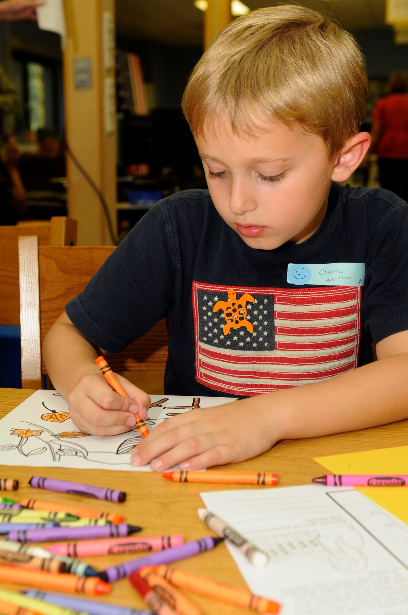 SPANGDAHLEM AIR BASE, Germany -- Charles Wortman, son of Master Sgt. Charles Wortman, 606th Air Control Squadron, colors a picture for his dad during Deployment Club at Spangdahlem Elementary School Sept. 28. The Deployment Club is an after-school event held monthly while school is in session. It allows children whose parents are deployed to cope and navigate the many unique situations they may face. The children decorate posters, color pictures and talk with each other about their experiences. (U.S. Air Force photo/Airman 1st Class Brittney Frees)