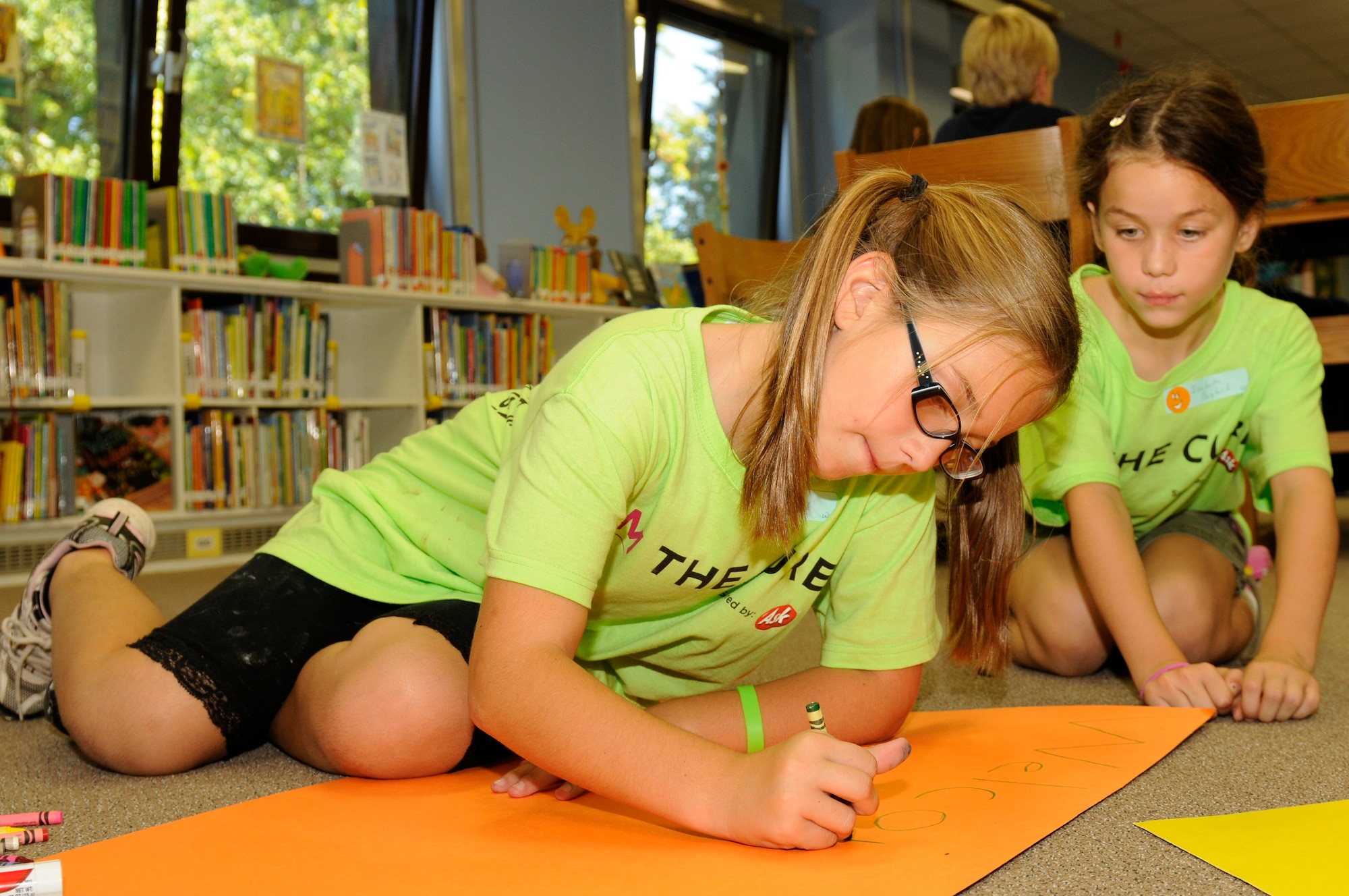 SPANGDAHLEM AIR BASE, Germany -- Linda, left, and Isabella Naglack, daughters of Tech. Sgt. Mark Naglack, 52nd Equipment Maintenance Squadron, decorate a welcome home poster for their dad during Deployment Club at the Spangdahlem Elementary School Sept. 28. The Deployment Club is an after-school event held monthly while school is in session. It allows children whose parents are deployed to cope and navigate the many unique situations they may face. The children decorate posters, color pictures and talk with each other about their experiences. (U.S. Air Force photo/Airman 1st Class Brittney Frees)