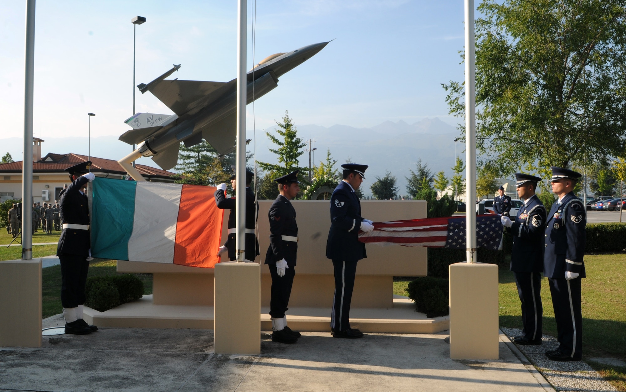 Aviano Air Base Honor Guard and Italian air force members fold the flags during a POW/MIA retreat ceremony Sept. 29 at the 31st Fighter Wing Headquarters. In addition to the retreat ceremony, Team Aviano held a vigil run, citation vigil, 10K ruck march and burger burn throughout the whole week as part of POW/MIA commemoration week. (U.S. Air Force photo/Staff Sgt. Julius Delos Reyes)