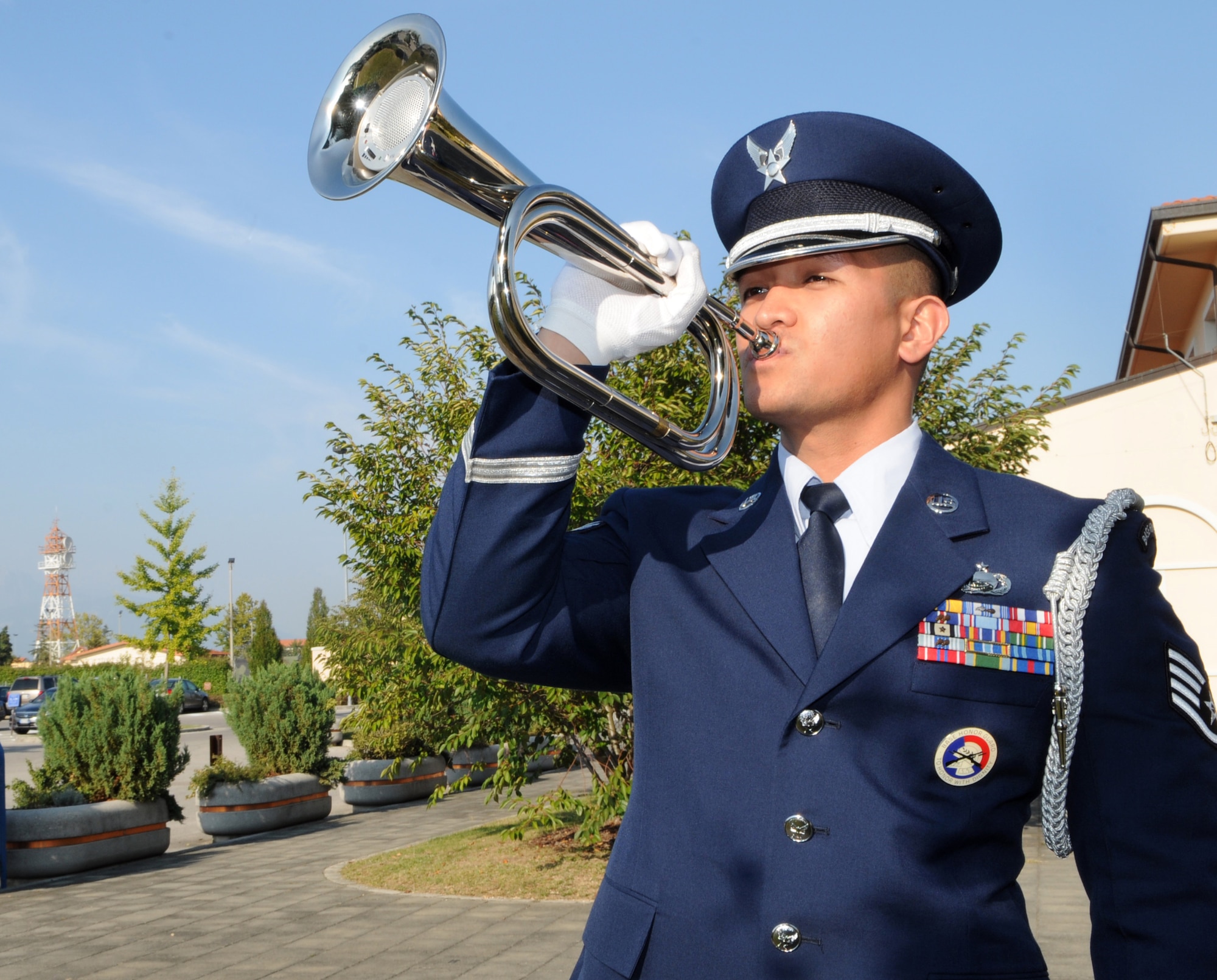 Staff Sgt. Kenneth De Gracia Aviano Air Base Honor Guard NCO, plays "Taps" during a POW/MIA retreat ceremony Sept. 29 at the 31st Fighter Wing Headquarters. Team Aviano hosted a series of activities to honor the prisoners of war and missing in action. (U.S. Air Force photo/Staff Sgt. Julius Delos Reyes)