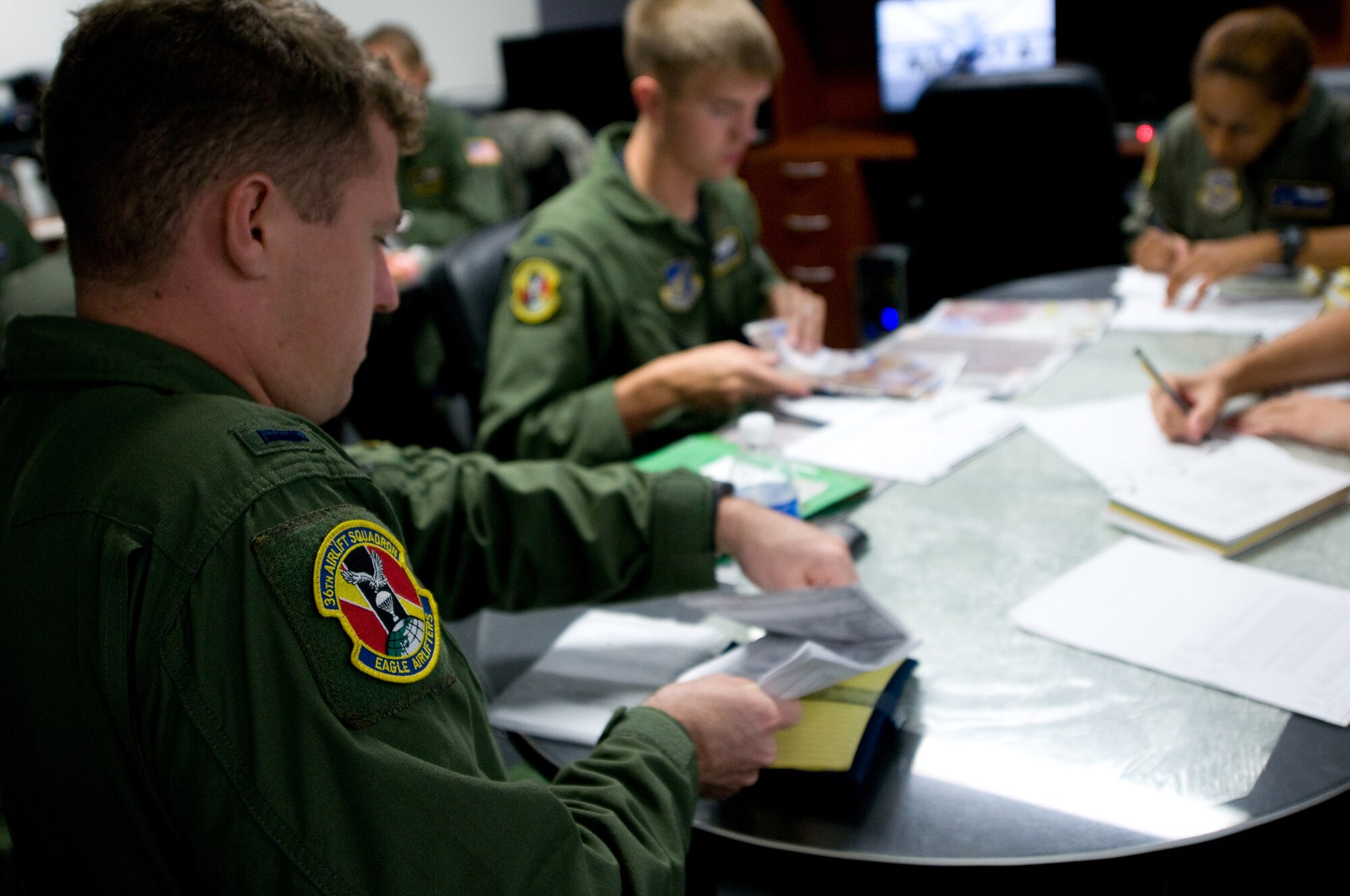 YOKOTA AIR BASE, Japan -- 1st Lt. Evan Dineen, 36th Airlift Squadron pilot, gathers paperwork during a pre-flight briefing at Yokota Air Base, Japan, Sept. 27, 2011. Pre-flight briefings ensure that all flight crew members are ready for the mission at hand. (U.S. Air Force photo/Airman 1st Class Krystal M. Garrett)

