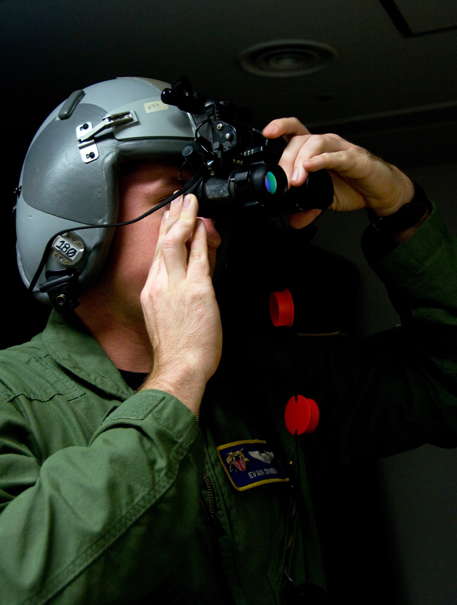YOKOTA AIR BASE, Japan -- 1st Lt. Evan Dineen, 36th Airlift Squadron pilot, tests out his night vision goggles before heading out for a flight at Yokota Air Base, Japan, Sept. 27, 2011. Dineen is a native of Laguna Beach, Calif.  (U.S. Air Force photo/Airman 1st Class Krystal M. Garrett) 