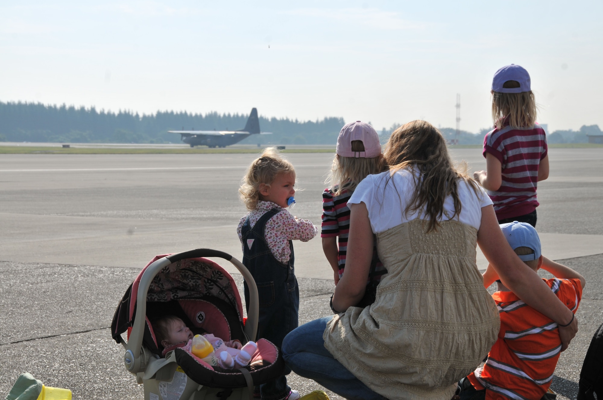 YOKOTA AIR BASE, Japan -- The Hansen family bids farewell to their deploying father Sept. 30, 2011, at Yokota Air Base, Japan. Though he will be deployed through the holidays, the Yokota Airman and Family Readiness center will have a variety of activities to help the family pass the time. (U.S. Air Force photo/Airman 1st Class Desiree Economides)