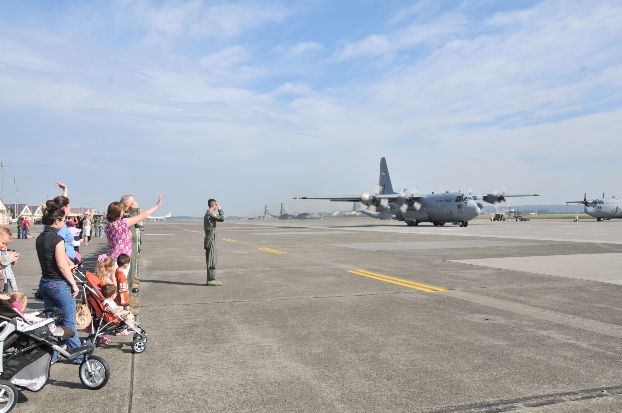 YOKOTA AIR BASE, Japan -- Airmen from the 36th Airlift Squadron and family members say farewell to a crew leaving for deployment Sept. 30, 2011, at Yokota Air Base, Japan. The crew will be deployed for several months throughout Southwest Asia. (U.S. Air Force photo/Airman 1st Class Desiree Economides)