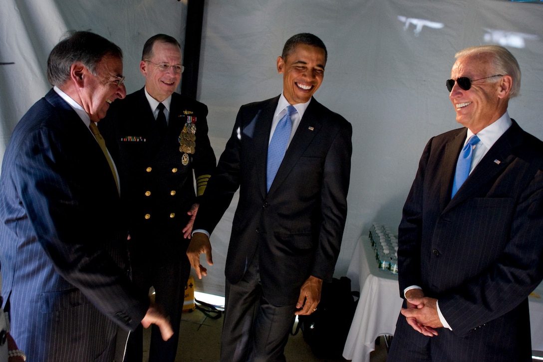 President Barack Obama and Vice President Joe Biden speak with Defense Secretary Leon E. Panetta and Navy Adm. Mike Mullen, outgoing chairman of the Joint Chiefs of Staff, during the Chairman of the Joint Chiefs of Staff change of responsibility ceremony on Joint Base Myer-Henderson Hall, Va., Sept. 30, 2011.