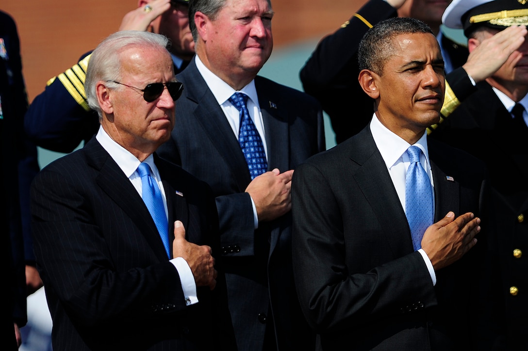 President Barack Obama and Vice President Joe Biden observe the playing of the national anthem during the Chairman of the Joint Chiefs of Staff change of responsibility ceremony on Joint Base Myer-Henderson Hall, Va., Sept. 30, 2011. Army Gen. Martin E. Dempsey became the 18th chairman of the Joint Chiefs of Staff during the ceremony, succeeding Navy Adm. Mike Mullen who retired after 43 years of military service. 