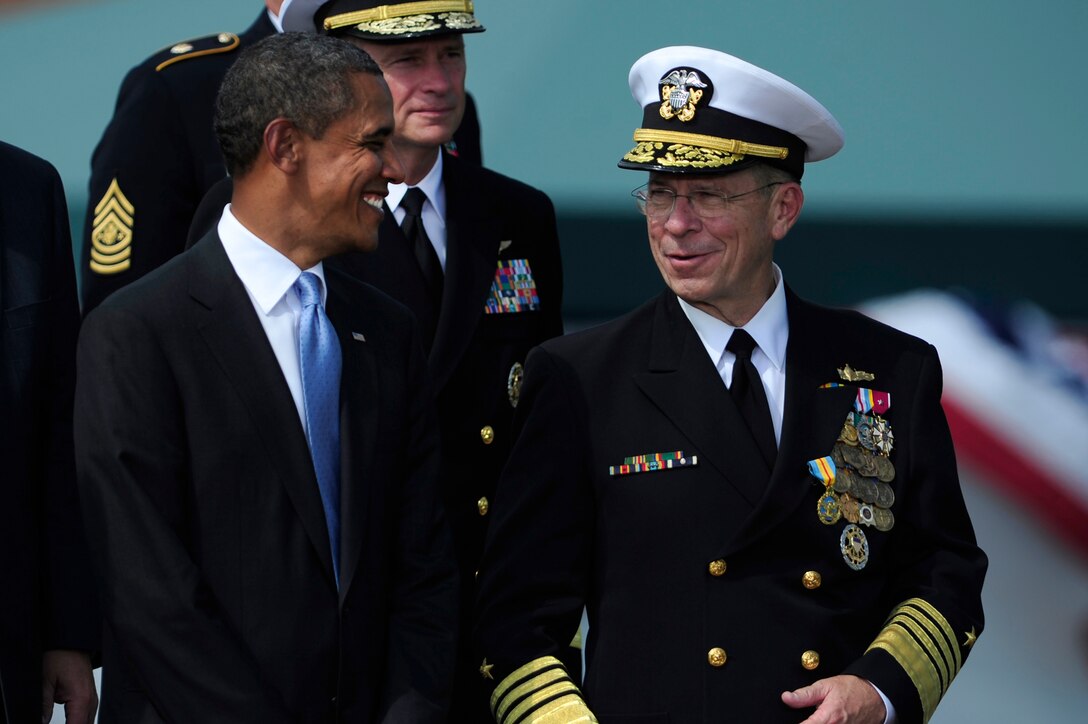 President Barack Obama, left, shares a moment with Navy Adm. Mike Mullen, outgoing chairman of the Joint Chiefs of Staff, during the Chairman of the Joint Chiefs of Staff change of responsibility ceremony on Joint Base Myer-Henderson Hall, Va., Sept. 30, 2011. Mullen was succeeded by Army Gen. Martin E. Dempsey, who became the18th chairman of the Joint Chiefs of Staff, during the ceremony.