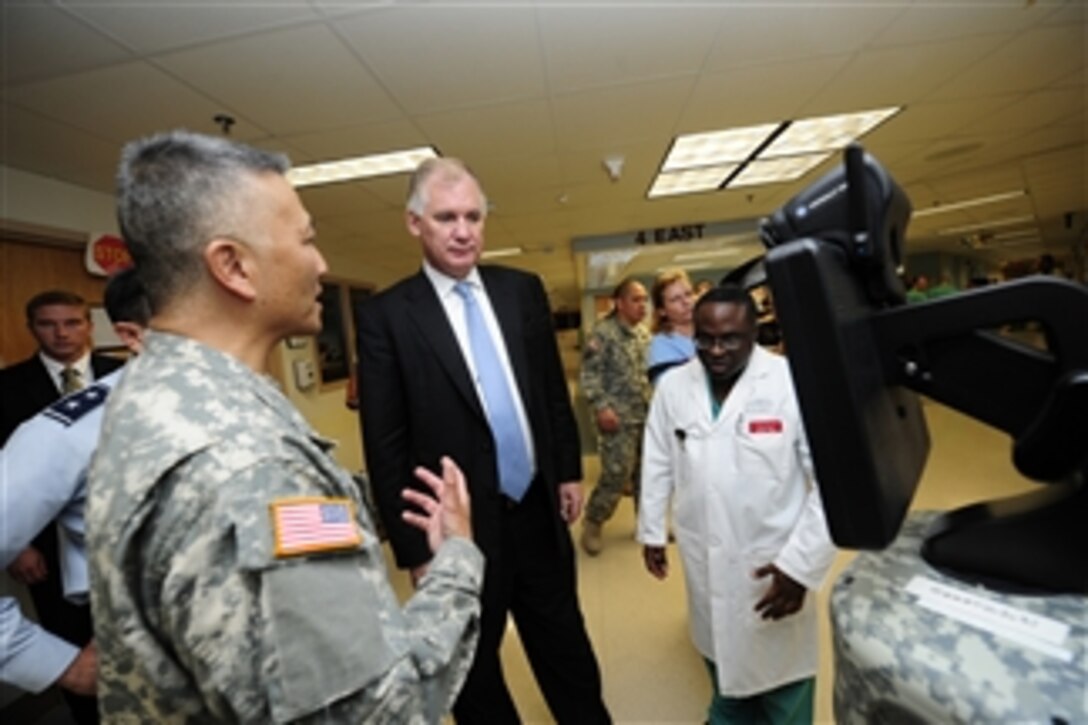 Army Maj. Gen. M. Ted Wong tells Deputy Secretary of Defense William J. Lynn III about an advanced medical monitor that utilizes videoconferencing technology at the Brooke Army Medical Center, San Antonio, Texas, on Sept. 28, 2011.  Lynn is touring the facility to meet with staff and patients.  