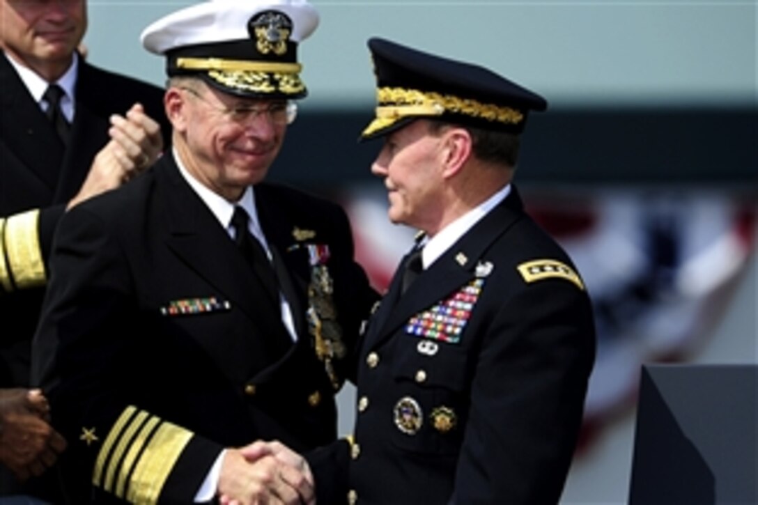 Navy Adm. Mike Mullen, left, outgoing chairman of the Joint Chiefs of Staff, congratulates the new chairman of the Joint Chiefs of Staff, Army Gen. Martin E. Dempsey, during the Chairman of the Joint Chiefs of Staff change of responsibility ceremony on Joint Base Myer-Henderson Hall, Va., Sept. 30, 2011. Mullen retired after 43 years of service and Dempsey became the 18th chairman of the Joint Chiefs of Staff during the ceremony.