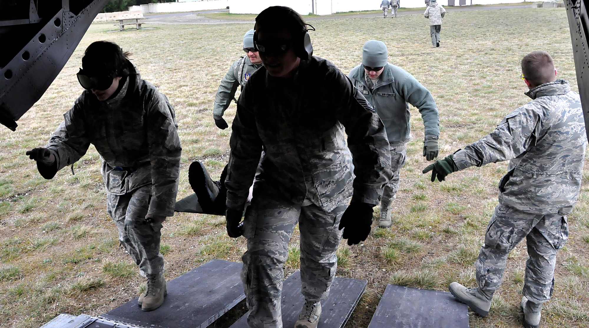 446th AES airmen load a patient into a CH-47 Chinook helicopter during an EMT refresher course on Fort Lewis, Wash. on Sunday, April 1st. Their unit is the only one in the Air Force with such a hands-on training curriculum to update their EMT skills.