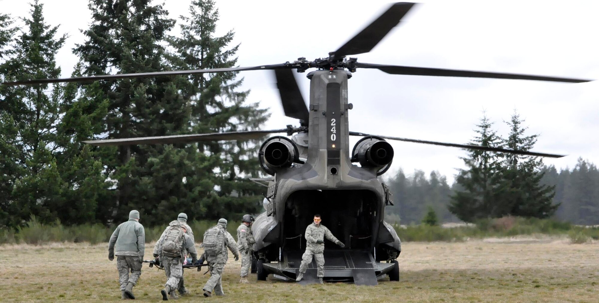 446th AES airmen load a patient into a CH-47 Chinook helicopter during an EMT refresher course on Fort Lewis, Wash. on Sunday, April 1st. Their unit is the only one in the Air Force with such a hands-on training curriculum to update their EMT skills.