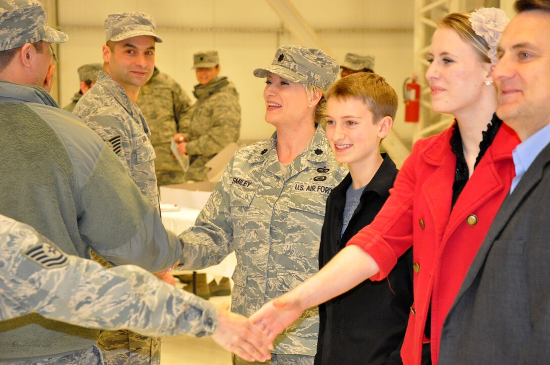 With her family by her side, Lt. Col. Kelli Smiley (center) greets Reservists from the 446th Force Support Squadron following a change of command ceremony at McChord Field, Wash. on Saturday, March 31st. Colonel Smiley assumed command from Lt. Col. William Pelster, now retired. The new commander comes armed with a quick smile and a strong appreciation for family, both military and personal. (U.S. Air Force photo/Staff Sgt. Grant Saylor)