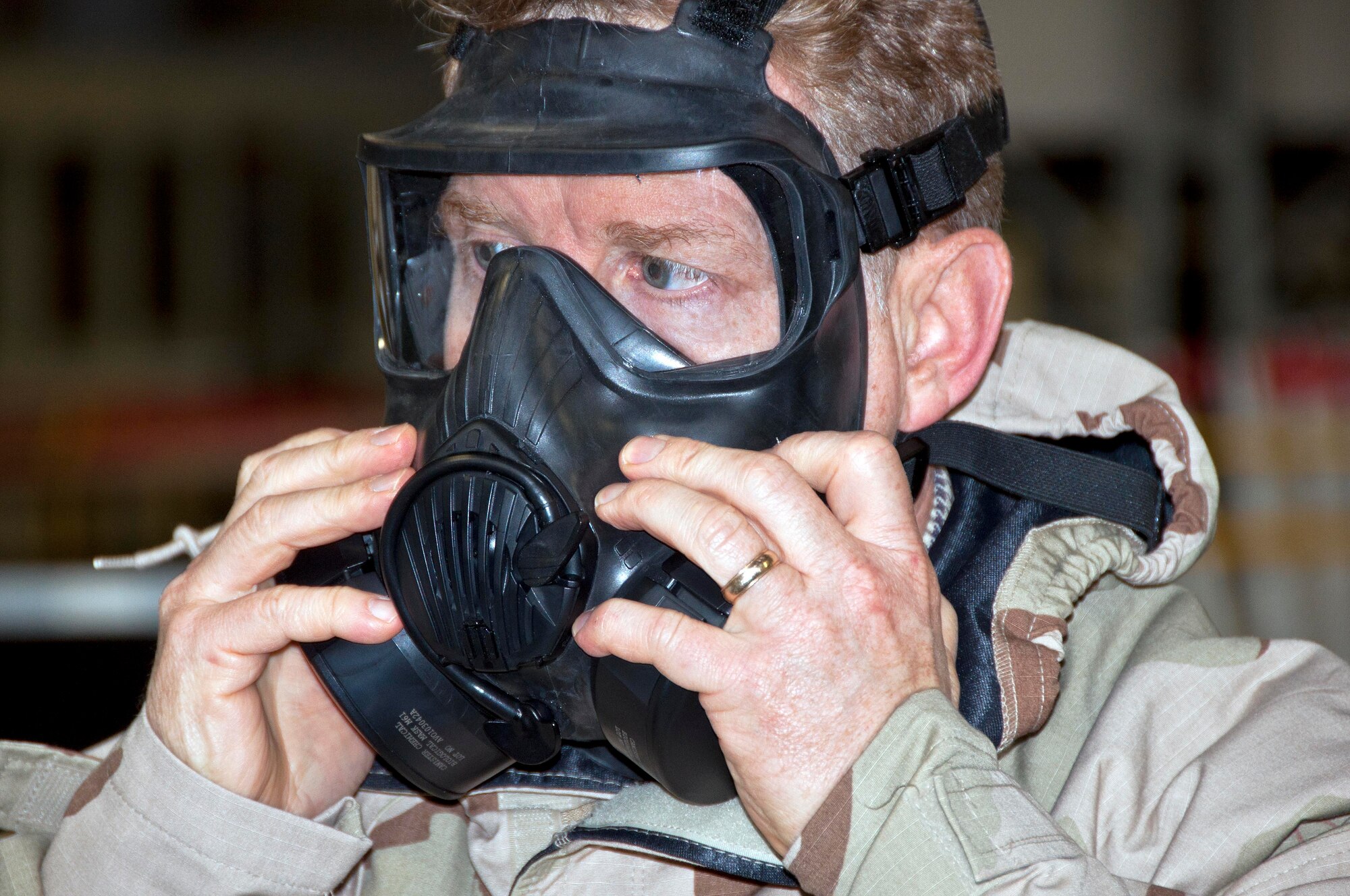 Ron Arnold, Puget Sound Naval Shipyard, dons an M-50 gas mask during deployment briefings on the 446th Airlift Wing's Employer Orientation Day held March 31 here.  More than 30 civilian employers of 446th AW's members participated in the event. (U.S. Air Force photo by Tech. Sgt. Tanya King)