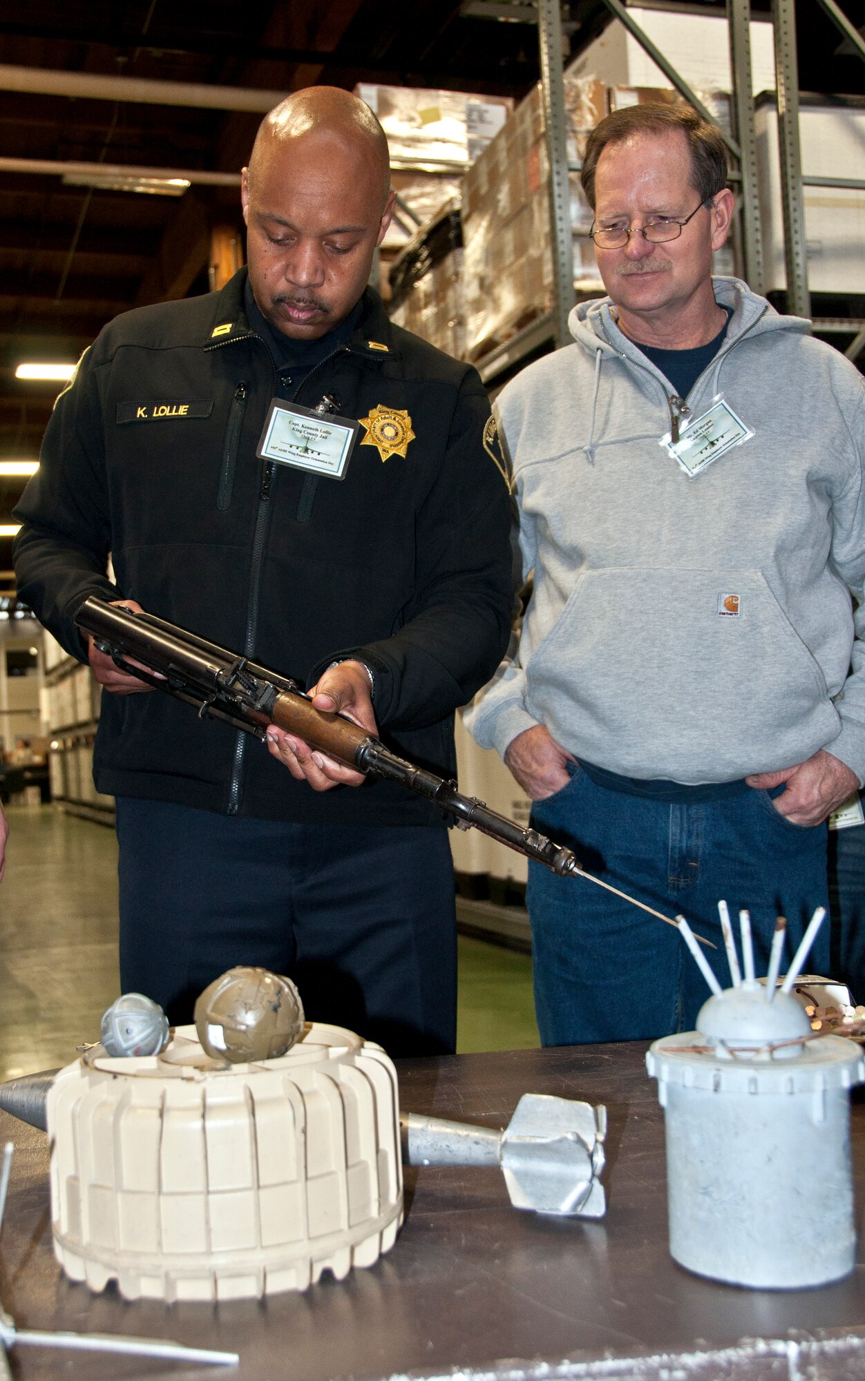 Capt. Ken Lollie (left), King County Jail, and Ed Morgan, Simpson Lumber, examine a bayonette at the 446th Airlift Wing's Employer Orientation Day held March 31 here.  More than 30 civilian employers of 446th AW's members participated in the event.