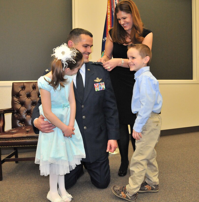 MCCHORD FIELD, Wash. Newly promoted Col. Rick Grayson gets pinned on by his family March 30 at McChord Field.  Grayson is the new vice commander for the 446th Airlift Wing.  In his civilian life, Grayson is a 737 first officer for Alaska Airlines, and lives in Gig Harbor with his wife and two children. (U.S. Air Force photo by 2nd Lt. Denise Hauser)