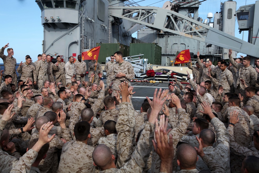 Col. Frank Donovan, center, commander of the 24th Marine Expeditionary Unit, tallies the number of Marines and Sailors on their first MEU deployment as they make their way across the Atlantic Ocean, April 1, 2012. Donovan spent the day aboard the ship to better acquaint himself with the living conditions and morale of the Marines and Sailors. The 24th MEU, partnered with the Navy's Iwo Jima Amphibious Ready Group, is deploying to the European and Central Command theaters of operation to serve as a theater reserve and crisis response force capable of a variety of missions from full-scale combat operations to humanitarian assistance and disaster relief.