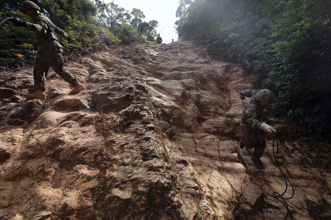 Marines with Combat Logistic Regiment 37 performs a hasty rappel down a hill at JWTC on Camp Gonsalves April 2. Rappelling skills prepare Marines to overcome potential obstacles during deployments. The CLR-37 Marines are assigned to 3rd Marine Logistics Group, III Marine Expeditionary Force.
