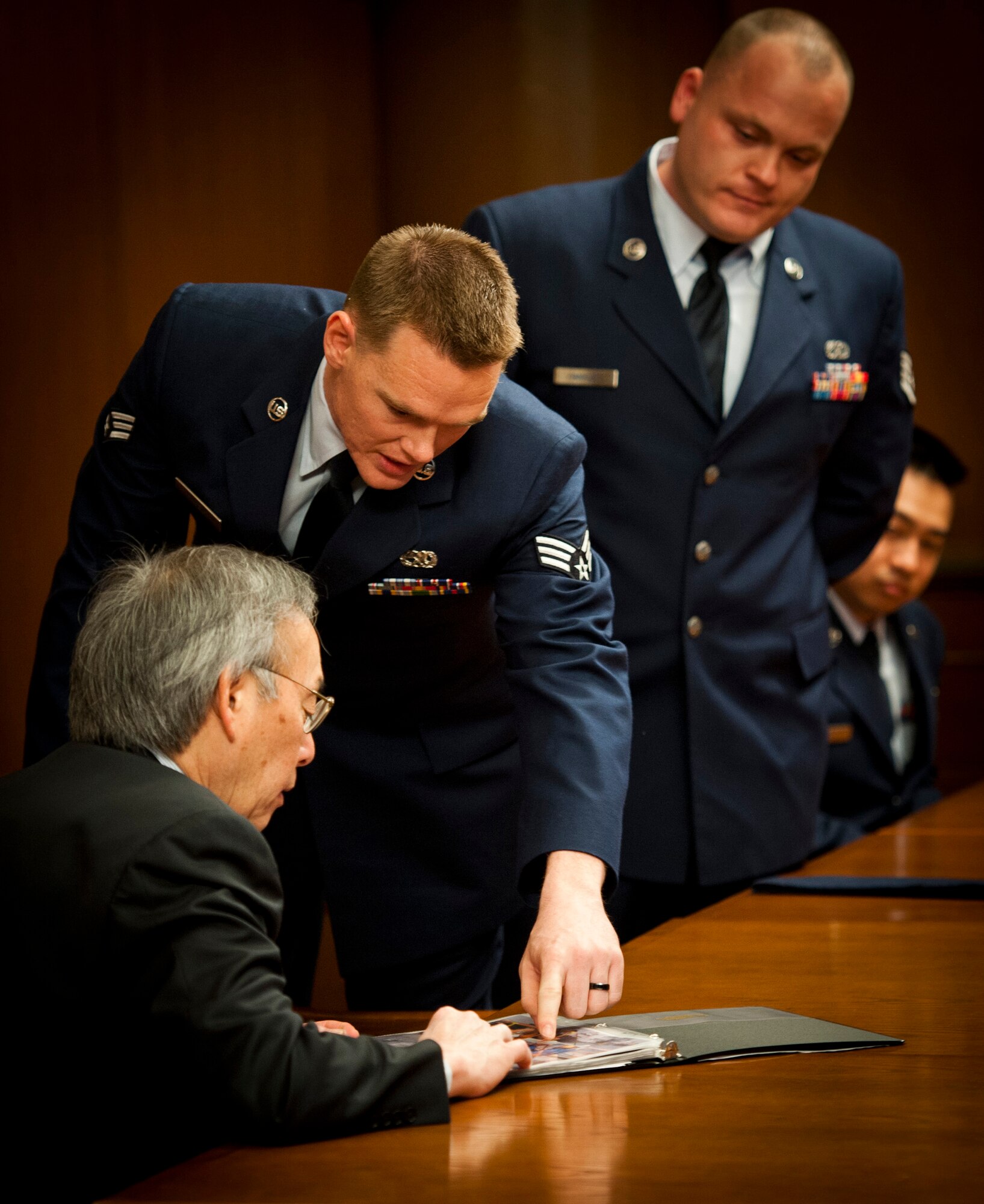 TOKYO -- Senior Airman Jeremy Hamblin, 374th Maintenance Squadron, talks to U.S. Secretary of Energy, Dr. Steven Chu, at the U.S. Embassy in Tokyo on March 30, 2012. Chu visited Tokyo and asked to speak with the Airmen involved in working with the Department of Energy during Operation Tomodachi, the recovery effort following the great Tohoku Earthquake and Tsunami March 11, 2011. (U.S. Air Force photo/Staff Sgt. Samuel Morse)