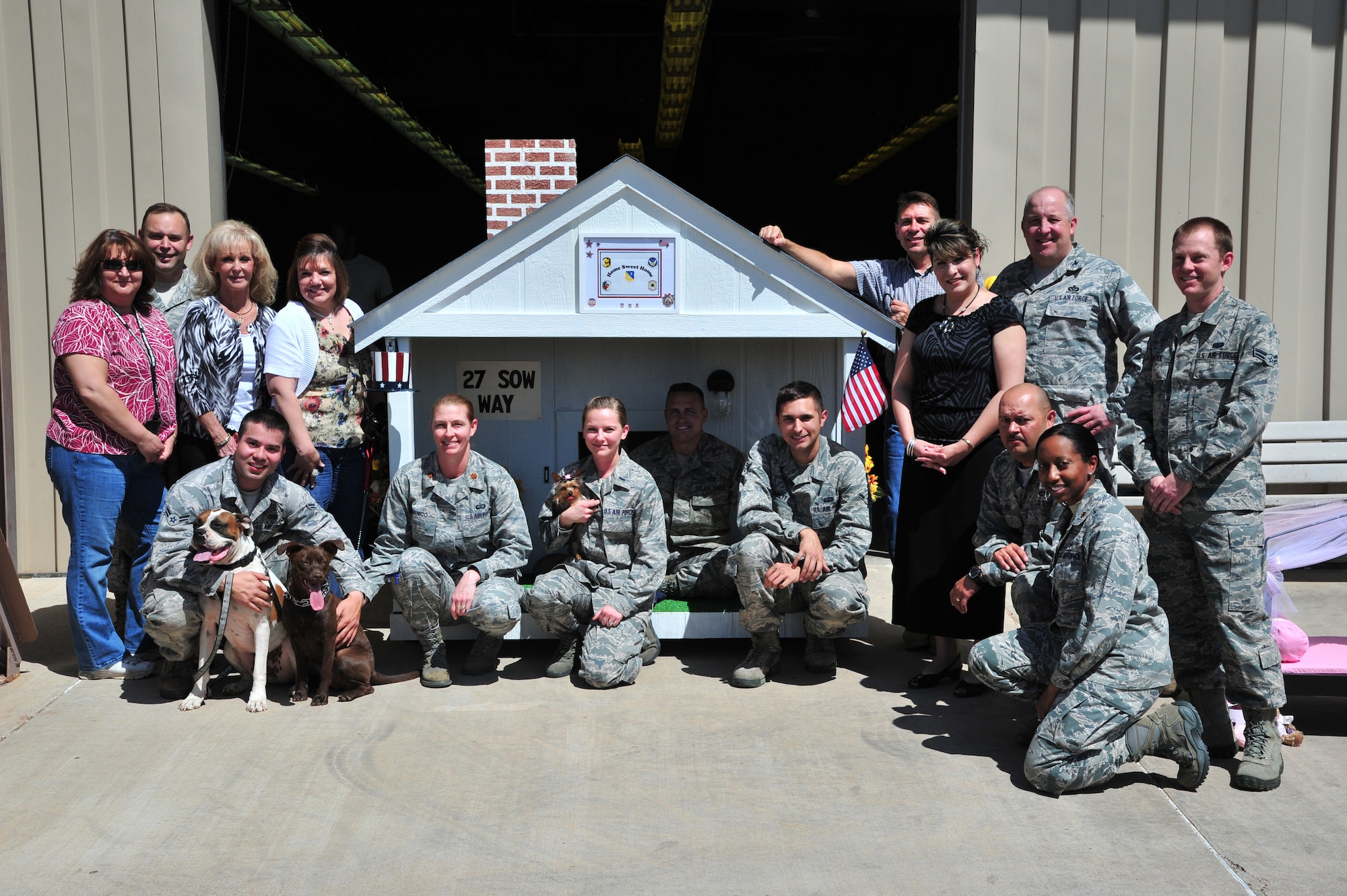 U.S. Air Force Air Commandos gather around one of their completed animal homes near the Structure Shop at Cannon Air Force Base, N.M., March 30, 2012. This is just one of the houses Cannon Airmen will donate to an upcoming Home and Garden show to help raise money for a local animal shelter. (U.S. Air Force photo by Airman 1st Class Xavier Lockley) 