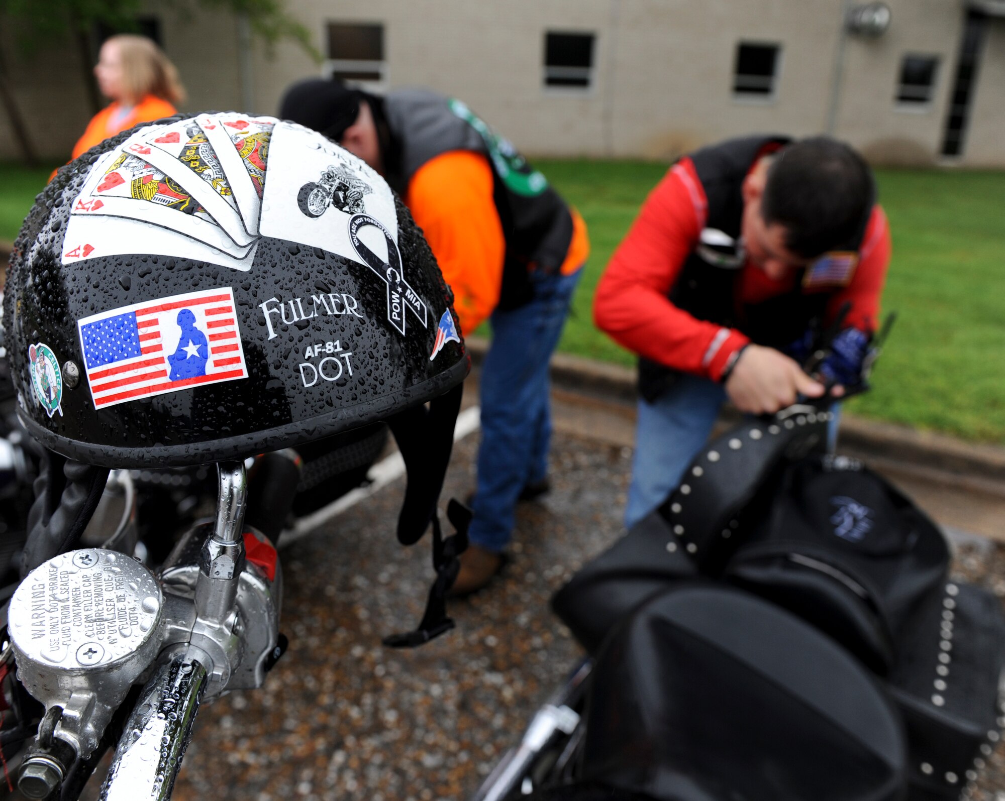 A helmet rests on the handle bars of a motorcycle while riders prepare for Thunder on the Bayou on Barksdale Air Force Base, La., March 30. Approved helmets, gloves and sturdy over-the-ankle foot wear are a few items that active-duty, guard and reserve Airmen must wear while on motorcycles as part of their personal protective equipment. Riders are also encouraged to wear bright colors to increase visibility. (U.S. Air Force photo/Airman 1st Class Micaiah Anthony)(RELEASED) 