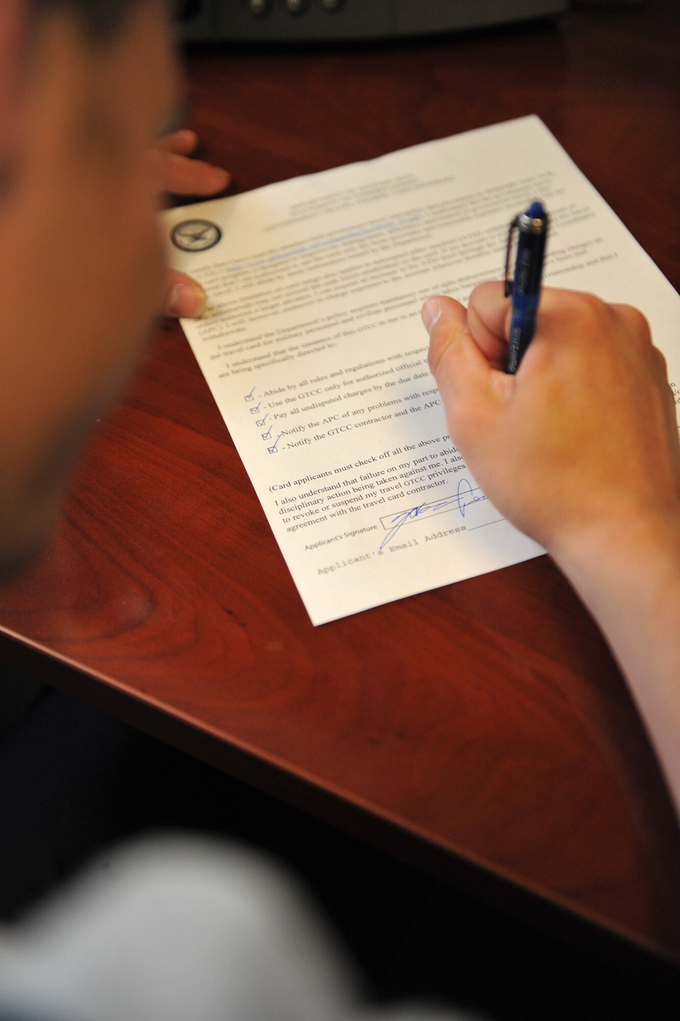 A U.S. Air Force Airman signs a Statement of Understanding in order to apply for a Government Travel Card, April 2, 2012, at Mountain Home Air Force Base, Idaho. The GTC will replace the existing Controlled Spend Account travel card by the end of fiscal 2012. (U.S. Air Force photo/Airman 1st Class Heather Hayward)