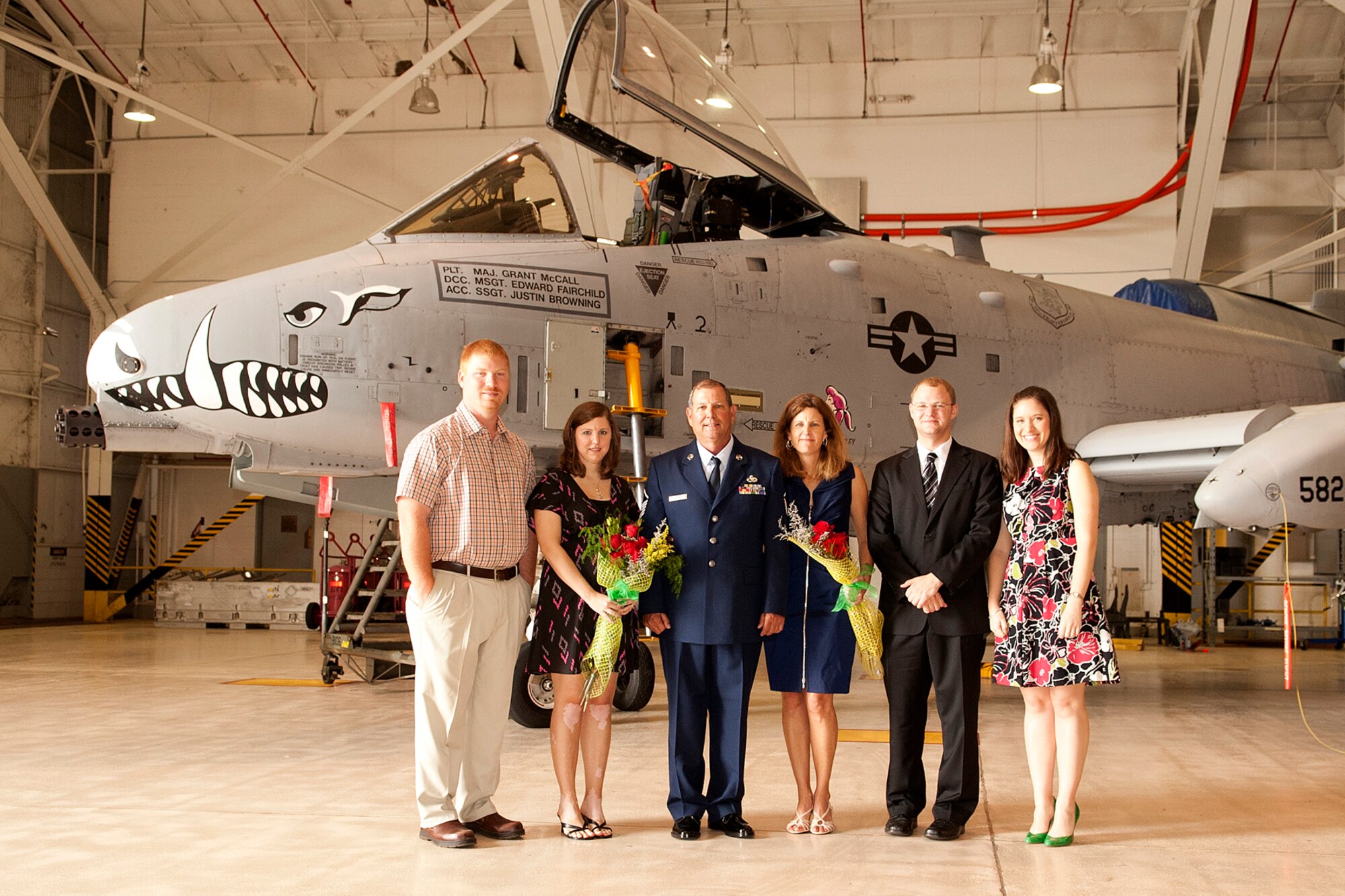 U.S. Air Force Master Sgt. William Murray takes a photo with his wife and family following his retirement ceremony at Barksdale Air Force Base, La., April 1, 2012. Murray retired from the Air Force Reserve after more than 30 years of service, most of which was spent as an Armament Systems Technician on the A-10 Thunderbolt II. (U.S. Air Force photo by Master Sgt. Greg Steele/Released)