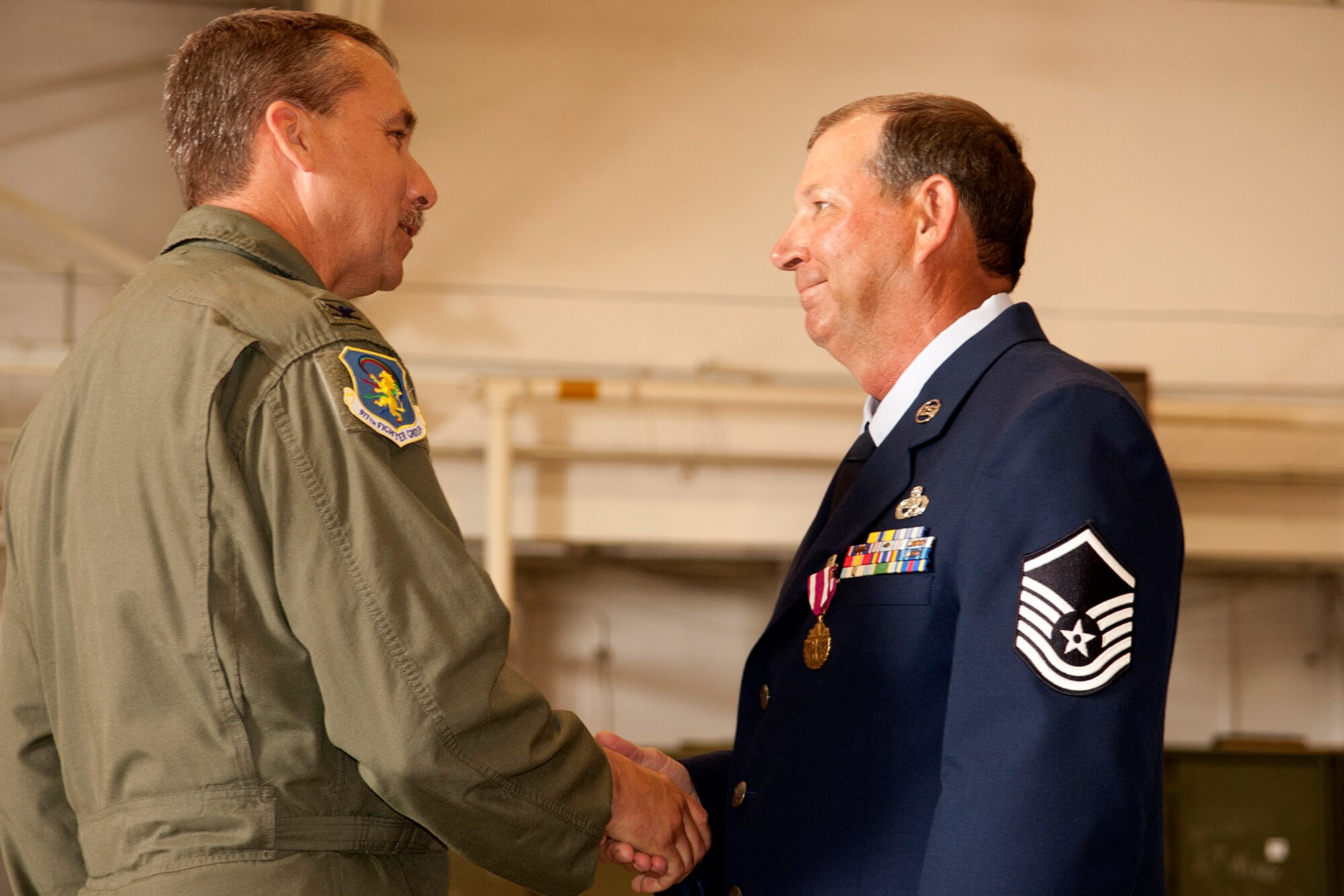 U.S. Air Force Col. John Breazeale, 917th Fighter Group commander, congratulates Master Sgt. William Murray on his retirement during a ceremony at Barksdale Air Force Base, La., April 1, 2012. Murray spent most of his career as an Armament Systems Technician on the A-10 Thunderbolt II and is retiring from the Air Force Reserve after more than 30 years of service. (U.S. Air Force photo by Master Sgt. Greg Steele/Released)