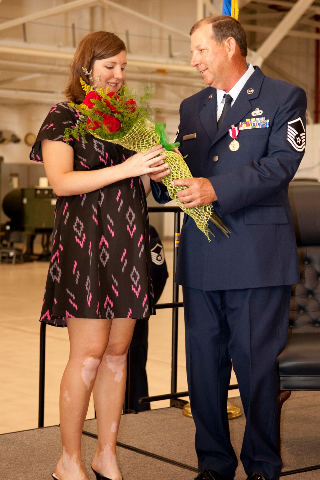 U.S. Air Force Master Sgt. William Murray presents flowers to his daughter Janet during his retirement ceremony at Barksdale Air Force Base, La., April 1, 2012. Murray joined the Air Force Reserve in 1982 and is retiring with over 30 years of total military service. (U.S. Air Force photo by Master Sgt. Greg Steele/Released)
