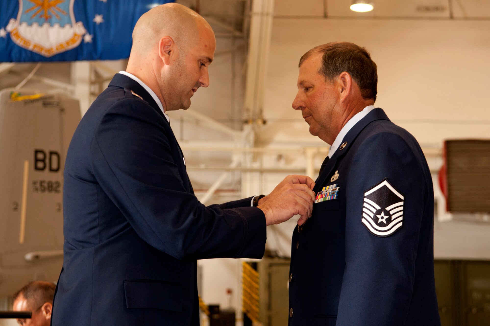 U.S. Air Force Capt. Brian Plauche, 917th Aircraft Maintenance Squadron maintenance officer, awards the Air Force Meritorious Service Medal to Master Sgt. William Murray during a retirement ceremony at Barksdale Air Force Base, La., April 1, 2012. Murray is retiring from the Air Force Reserve after more than 30 years of service. (U.S. Air Force photo by Master Sgt. Greg Steele/Released)