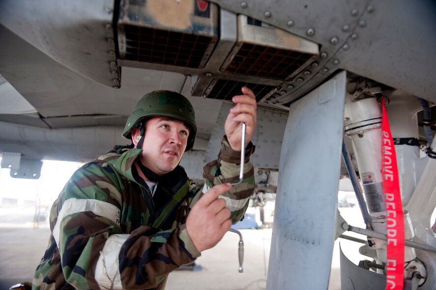 U.S. Air Force Senior Airman Kevin Davis, 476th Maintenance Squadron, removes an A-10C Thunderbolt II flare mount during a phase II operational readiness inspection at Moody Air Force Base, Ga., March 30, 2012. Flares are defensive mechanisms used to avoid detection and attacks by enemy air defense systems. Davis dismounted the flares as part of a post-flight recovery checklist for the aircraft. (U.S. Air Force photo by Staff Sgt. Jamal D. Sutter/Released)   