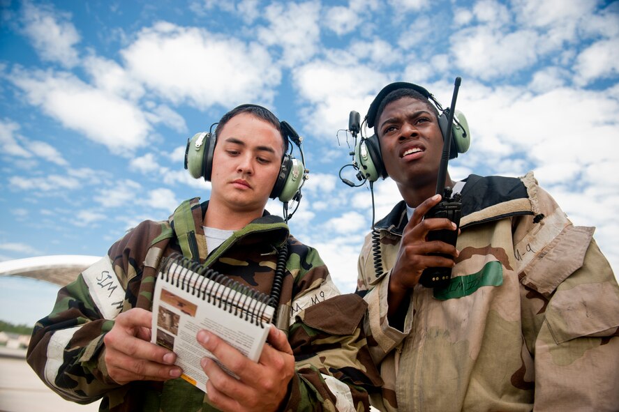 U.S. Air Force Senior Airman Stephen Grenat, 476th Maintenance Squadron, and Airman 1st Class Jontay Motley, 23d Aircraft Maintenance Squadron, review an Airman’s Manual while assessing a simulated unexploded ordnance situation during a phase II operational readiness inspection at Moody Air Force Base, Ga., March 30, 2012. Grenat and Motley were part of a post-attack reconnaissance team who found a UXO on the flightline after an attack. (U.S. Air Force photo by Staff Sgt. Jamal D. Sutter/Released)