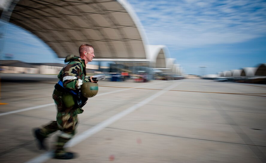U.S. Air Force Tech. Sgt. Jason Hough, 23d Aircraft Maintenance Squadron weapons armament systems specialist, runs for cover during a phase II operational readiness inspection at Moody Air Force Base, Ga., March 30, 2012. Throughout the inspection, Airmen had to demonstrate their ability to safely account for themselves, their wingman and 23d Wing assets during and after attacks. (U.S. Air Force photo by Staff Sgt. Jamal D. Sutter/Released) 