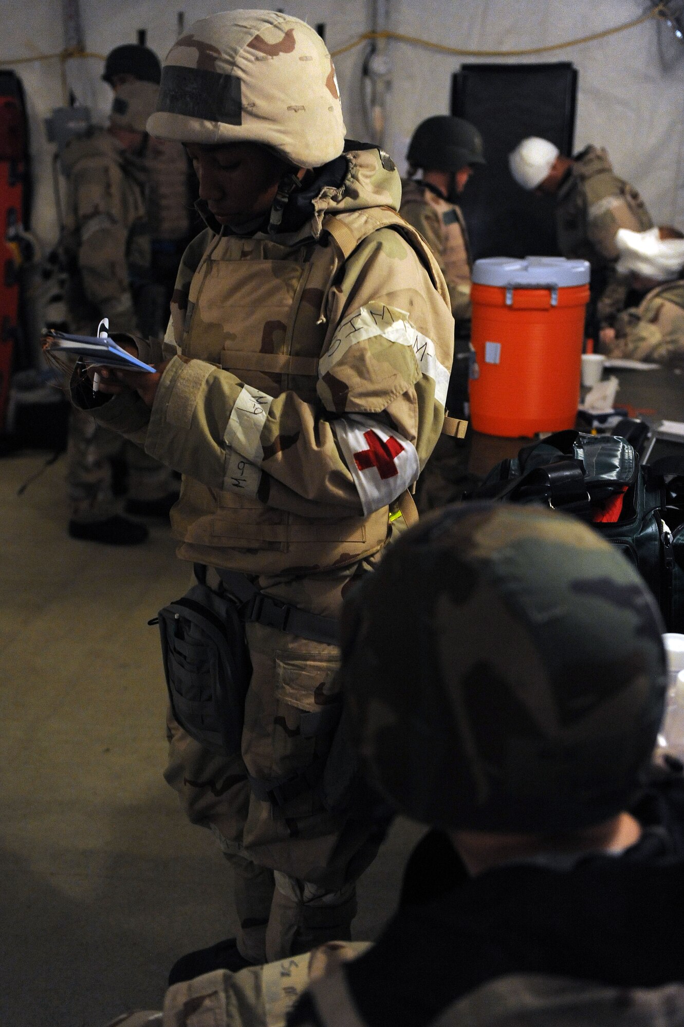 U.S. Air Force Staff Sgt. Evelyn Young, 23d Medical Operations Squadron, records simulated patient injuries during a phase II operational readiness Inspection inspection at Moody Air Force Base, Ga., March 30, 2012. During the ORI, Airmen were evaluated on their skills and knowledge to complete tasks within a deployed environment. (U.S. Air Force photo by Staff Sgt. Ciara Wymbs/Released) 