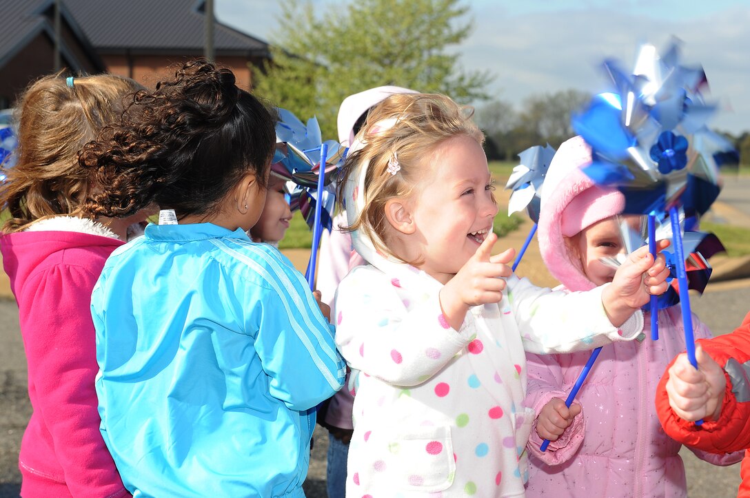 Caitlin Chapman, 4, cheers on her spinning pinwheel with classmates before planting it outside the Child Development Center at Langley Air Force Base, Va., April 2, 2012. Each pinwheel, planted in celebration of Child Abuse Prevention Month and Month of the Military Child, represents a child who deserves to be loved  (U.S. Air Force photo by Staff Sgt. Antoinette Gibson/Released)