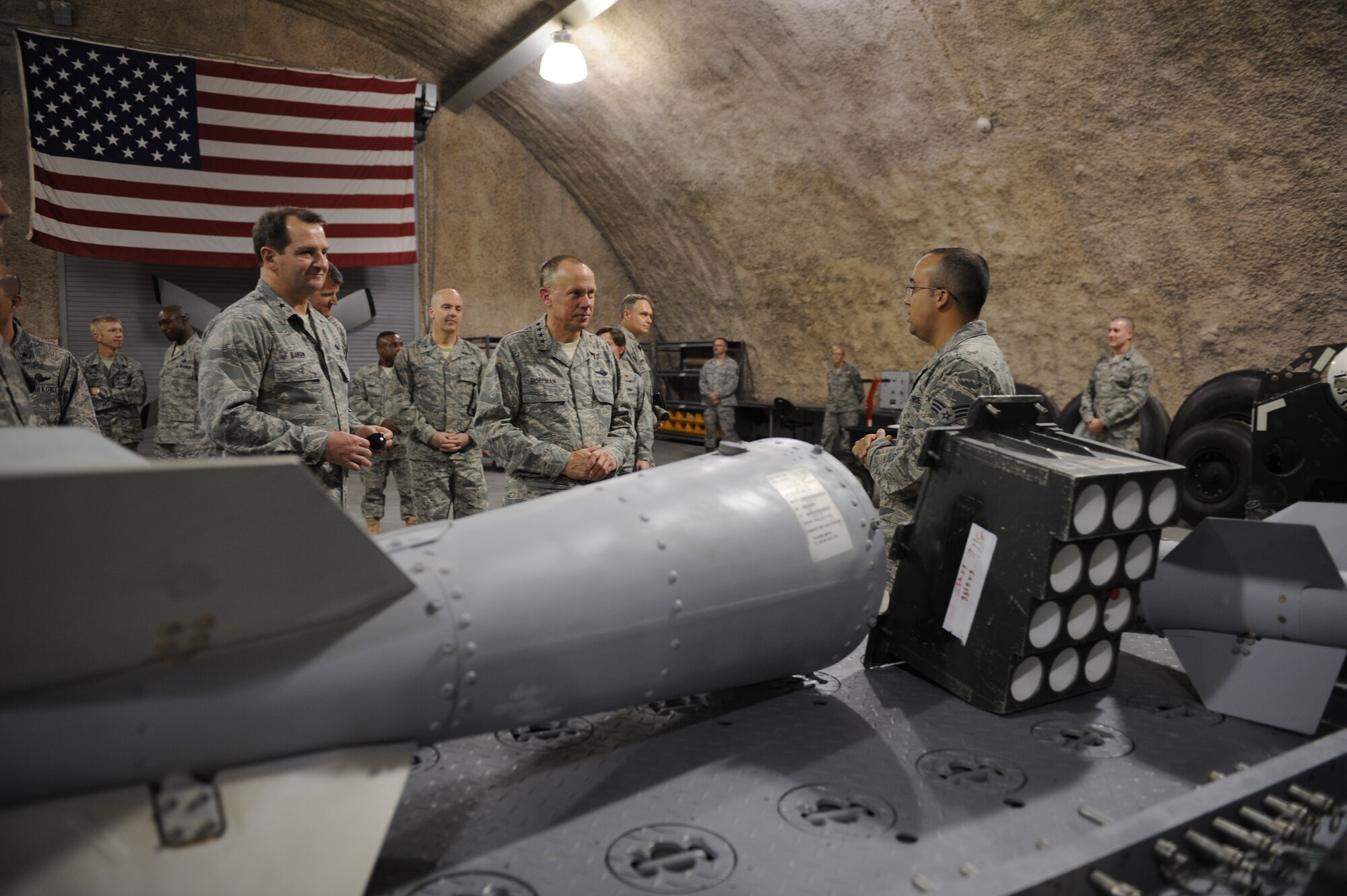 Gen. Donald Hoffman, AFMC commander, receives a briefing about the Joint Direct Attack Munition tailkit in the generalized repair facility of a base in Southwest Asia March 16, 2012. This stop was part of a trip through the U.S. Central Command's area of responsibility to acquire feedback directly from warfighters to determine how AFMC can better accomplish its supply and sustainment operations. (U.S. Air Force photo/Staff Sgt. Nathanael Callon)