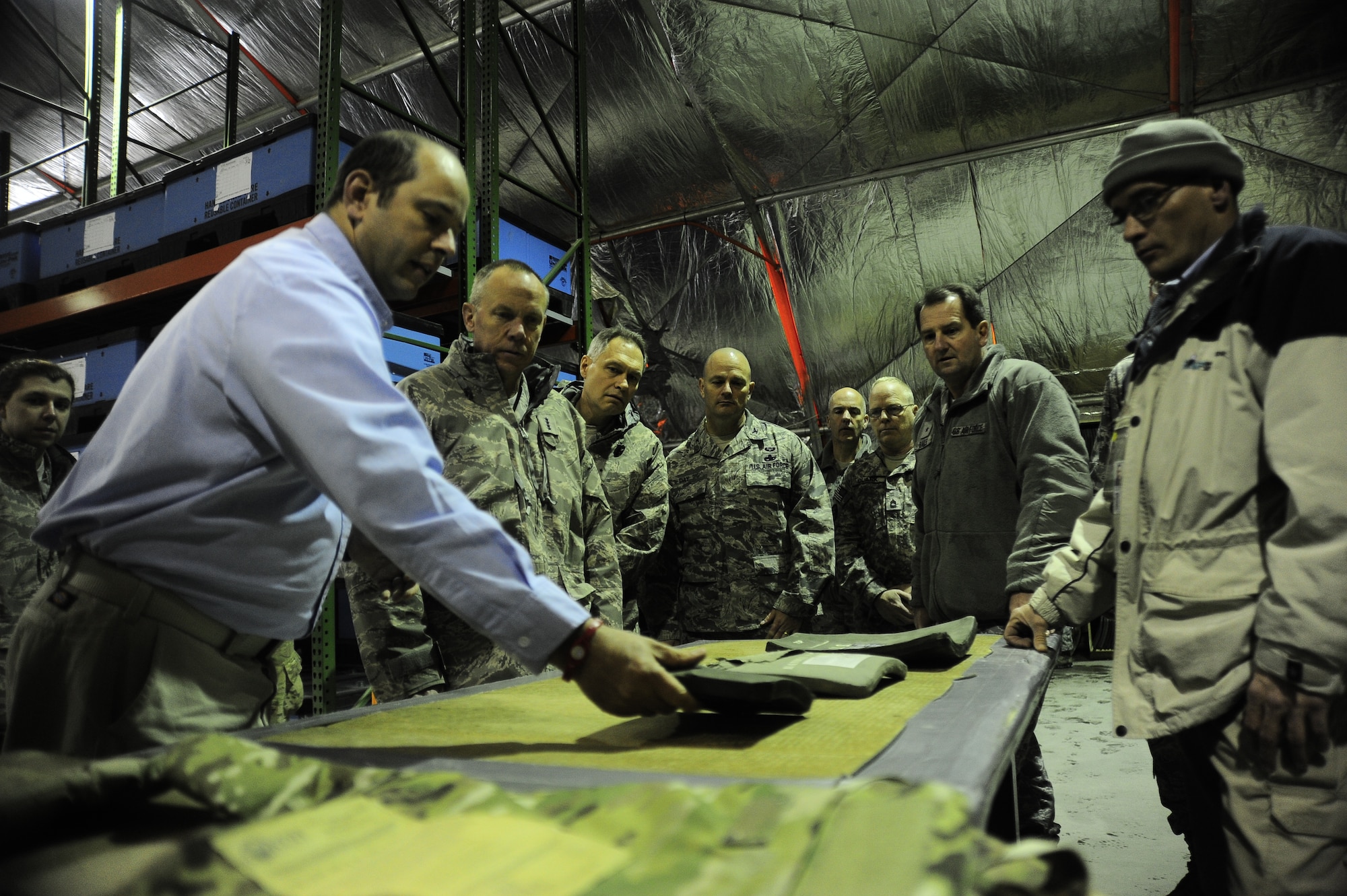 Andrew Aycock (left) demonstrates to AFMC Commander Gen. Donald Hoffman the results of a fracture in a protective insert for body armor March 19,2012, at the plate carrier collection point at the Transit Center at Manas. Aycock is a quality control specialist with IAP Worldwide Services and works at the Transit Center. This stop at the center was part of a trip through the U.S. Central Command's area of responsibility to acquire feedback directly from warfighters to determine how AFMC can better accomplish its supply and sustainment operations. (U.S. Air Force photo/ Staff Sgt. Angela Ruiz)
