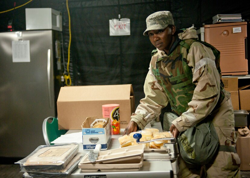 U.S. Air Force Tech Sgt. Tiffany Buford, 23d Force Support Squadron, prepares meals for the Airmen in the simulated deployed environment during the phase II operational readiness inspection at the field training exercise site March 30, 2012, at Moody Air Force Base, Ga. Every aspect of being on a deployment was evaluated during the inspection, and due to the wide-range of duties the 23d FSS are responsible for, they played a large role in the ORI. (U.S. Air Force photo by Senior Airman Eileen Meier/Released)