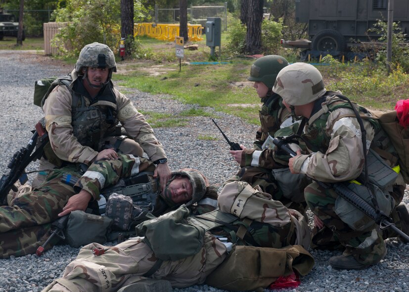 Participants in the phase II operational readiness inspection perform simulated self-aid buddy care to wounded Airmen at the field training exercise site March 30, 2012, at Moody Air Force Base, Ga. SABC falls within the ability to survive and operate category, commonly referred to as ATSO, and was a major part of the inspection. (U.S. Air Force photo by Senior Airman Eileen Meier/Released)